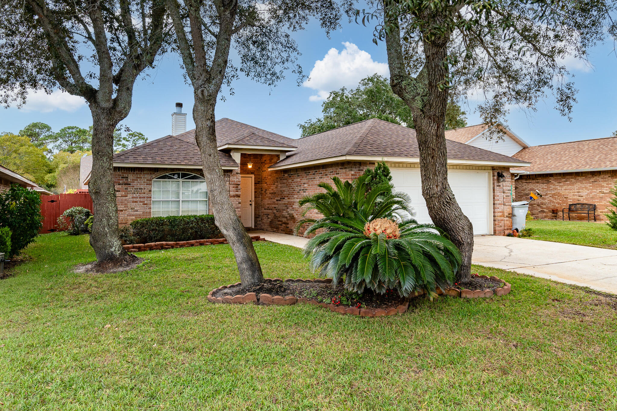 This well-maintained 3-bedroom, 2-bathroom home offers comfort, style, and convenience with a thoughtful layout. The spacious floor plan includes a separate dining room and a cozy breakfast area, perfect for both formal meals and casual gatherings. The kitchen is a standout feature with plenty of cabinet space, beautiful granite countertops, and a separate pantry for extra storage. Spacious living room with wood fireplace. A large laundry room adds practicality, providing ample space for organizing and handling household chores. The master suite is designed for privacy, located away from the other two bedrooms, and includes a generous walk-in closet, a double vanity, and a garden tub with a shower combination, offering a relaxing retreat. The home also features a 2-car garage, providing both parking and additional storage space. Exterior features include a fully privacy fenced back yard, a spacious covered patio and irrigation system. Recent upgrades add value and peace of mind, including a new roof installed in 2022 and wind mitigation features like hurricane clips, as well as hurricane-rated garage and front doors. The hot water heater was replaced in 2016, and the flooring throughout the home includes a combination of laminate, tile, and carpet, offering both durability and comfort. The chimney was inspected and cleaned about four years ago, although it has not been used by the current owner. The home is located in a well-maintained community with an HOA fee of $325 per year, which covers road maintenance and retention pond upkeep, ensuring the neighborhood remains attractive and functional. This home offers a blend of modern updates and practical features, making it a great choice for anyone looking for a comfortable and secure place to call home.