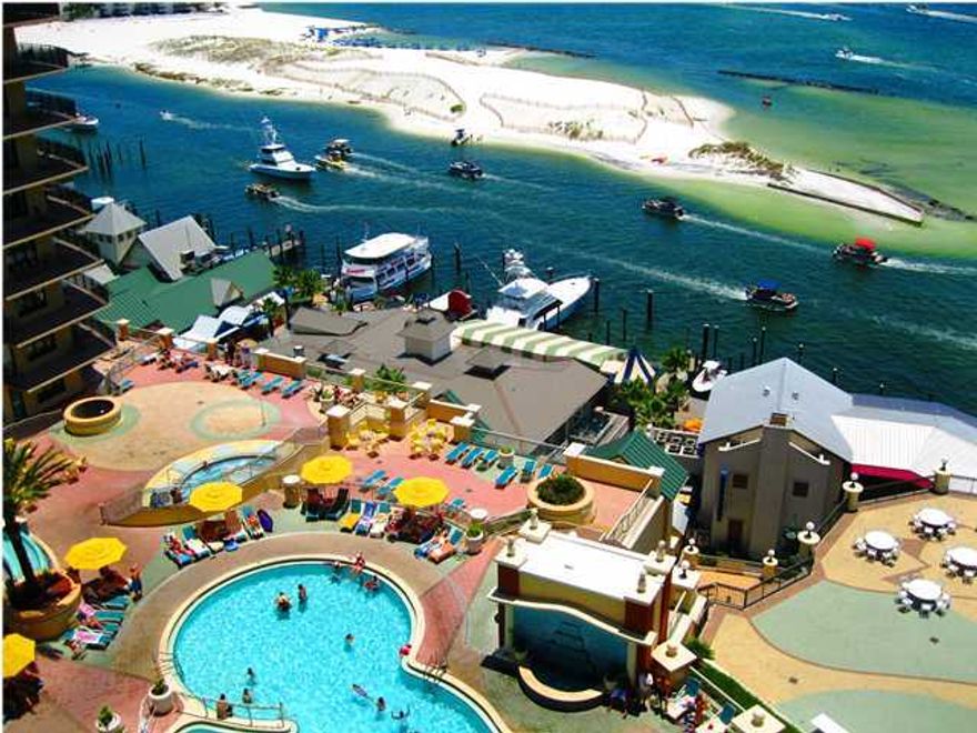 Beautifully decorated condo with spectacular views of the Destin Harbor, East Pass, and the pool deck make this the most desirable condo on the Emerald Coast. Amenities galore include 9700 sq ft European spa and fitness center, state-of-the-art business center with high speed wireless internet, onsite restaurants and lounges, two marinas, full service valet underground parking and ultra luxurious pool deck with harbor views. Interior design features include 9 ft ceilings in main living area and spacious balcony and grand terrace. Crown molding throughout. Kitchen includes stainless steel GE Profile appliances, granite counter top with bar and Italian porcelain floors. Bedrooms with Italian marble floors. Many, many more fabulous features! Plan W-5. Unit to be sold fully furnished and  AS-IS.  Currently on Emerald Grande Rental Program.  Grossed over $53,000 in rental revenue for 2012.