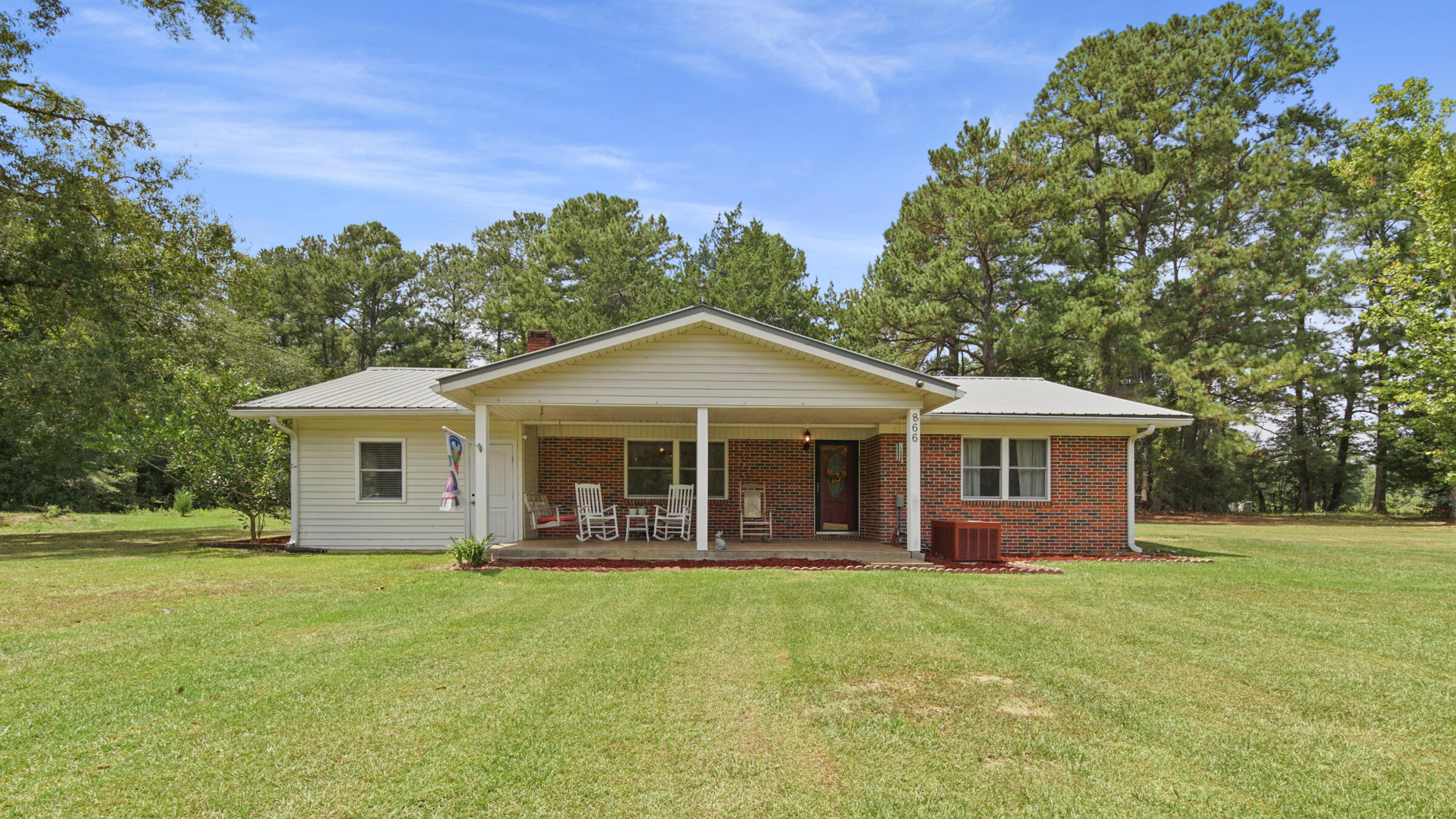 Back on market at no fault of seller - don't miss your chance! Come see this brick country home with metal roof on 10 acres in the desirable Eucheeanna Valley area just east of historic DeFuniak Springs. The eat-in kitchen is spacious with oak cabinets, granite countertops and stainless steel appliances. There is an oversized utility room off the kitchen along with a separate den, ideal as a home office or a 4th bedroom as well. The living room features a brick wood burning fireplace that will heat most of the house on those cold days. The bathroom has been completely updated. Outside is a small pond, 2 block outbuildings and a cleared garden area. Land is level with room for chickens, goats and living off grid. Only 10-15 minute drive to downtown DeFuniak and 30 minutes to the beach.