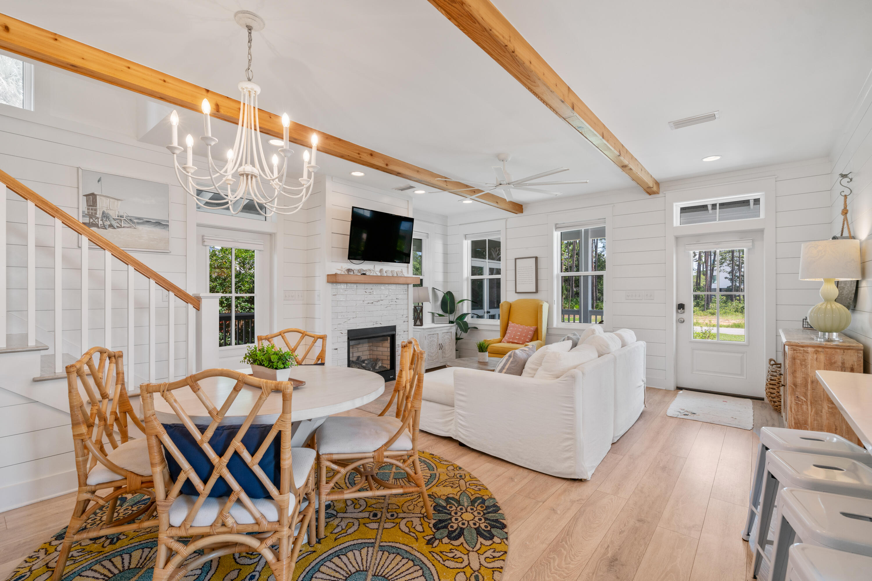 Welcome to your seaside sanctuary! This delightful beach cottage offers a perfect blend of classic charm and modern convenience, ideally located close to beach access, restaurants, and Topsail Hill State Park. Enjoy the soothing sea breeze and the convenience of beach outings in mere minutes. Step inside to discover a sunlit open-concept living space, where beamed ceilings, shiplap walls, and broad bleached oak flooring create a serene and inviting atmosphere. The centerpiece of the living area is a cozy fireplace, perfect for cool evenings after a day at the beach. Transoms over the doors and windows invite ample natural light and enhance the cottage's airy feel. The well-appointed kitchen features a central island with Quartz countertops, stainless steel appliances, and a charming apron-front sink. Whether you're whipping up a quick breakfast or entertaining guests, this space combines functionality with style.
The main level hosts a spacious primary bedroom, offering a peaceful retreat with easy access to the main living areas. The luxurious master bath is highlighted, featuring a deep oval garden tub and double vanity for comfort and convenience.
Upstairs, you'll find two guest bedrooms and a full bath, creating cozy nooks for relaxation or play.
The home also boasts two screened porches, perfect for enjoying your morning coffee or unwinding in the evenings. The fenced backyard provides ample space for outdoor activities and the potential to add a pool.
Additional features include a carport and ample parking. The cottage comes fully furnished, ready for you to move in and start enjoying the coastal lifestyle.
In a neighborhood with no HOA, this home offers the perfect primary home, secondary home, or vacation rental. Take advantage of this charming beach cottage; every detail has been thoughtfully designed to provide comfort and a touch of coastal style. All information is believed to be accurate but should be verified.
