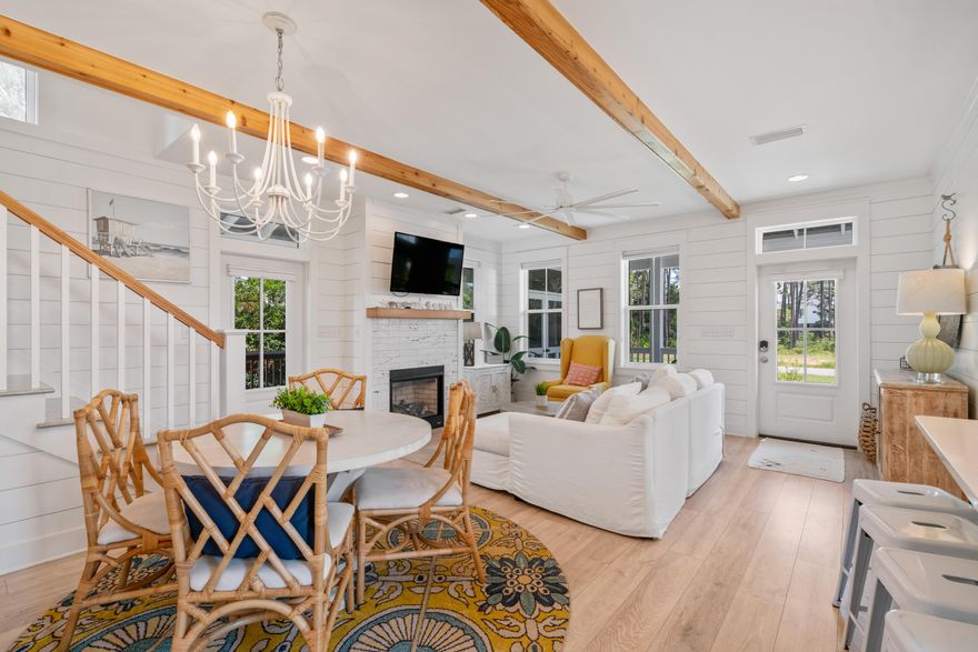 Welcome to your seaside sanctuary! This delightful beach cottage offers a perfect blend of classic charm and modern convenience, ideally located close to beach access, restaurants, and Topsail Hill State Park. Enjoy the soothing sea breeze and the convenience of beach outings in mere minutes. Step inside to discover a sunlit open-concept living space, where beamed ceilings, shiplap walls, and broad bleached oak flooring create a serene and inviting atmosphere. The centerpiece of the living area is a cozy fireplace, perfect for cool evenings after a day at the beach. Transoms over the doors and windows invite ample natural light and enhance the cottage's airy feel. The well-appointed kitchen features a central island with Quartz countertops, stainless steel appliances, and a charming apron-front sink. Whether you're whipping up a quick breakfast or entertaining guests, this space combines functionality with style.
The main level hosts a spacious primary bedroom, offering a peaceful retreat with easy access to the main living areas. The luxurious master bath is highlighted, featuring a deep oval garden tub and double vanity for comfort and convenience.
Upstairs, you'll find two guest bedrooms and a full bath, creating cozy nooks for relaxation or play.
The home also boasts two screened porches, perfect for enjoying your morning coffee or unwinding in the evenings. The fenced backyard provides ample space for outdoor activities and the potential to add a pool.
Additional features include a carport and ample parking. The cottage comes fully furnished, ready for you to move in and start enjoying the coastal lifestyle.
In a neighborhood with no HOA, this home offers the perfect primary home, secondary home, or vacation rental. Take advantage of this charming beach cottage; every detail has been thoughtfully designed to provide comfort and a touch of coastal style. All information is believed to be accurate but should be verified.