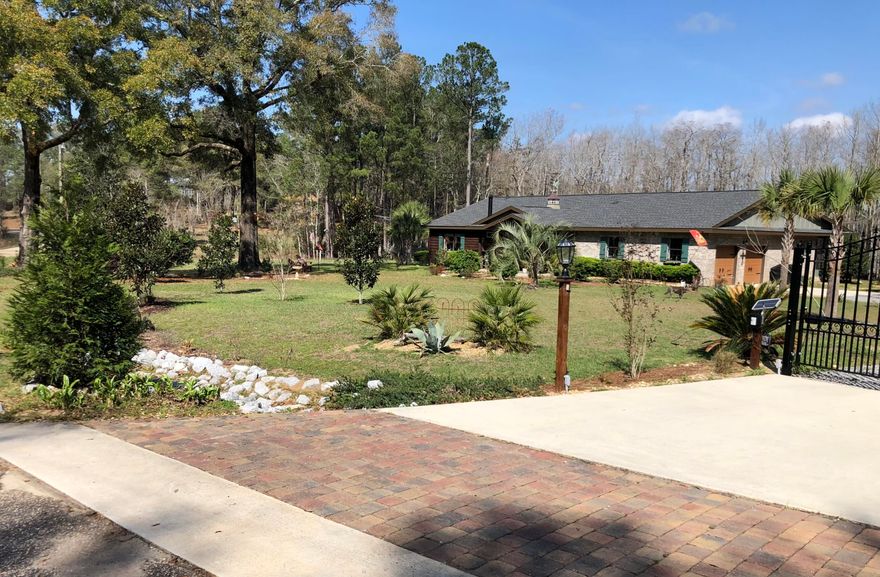 Waterfront escape on 1.91 acres with an exquisite home offering a blend of modern comfort with rustic charm. Step inside to discover a beautifully designed open floor plan seamlessly connecting living, dining, and kitchen while offering breathtaking lake views. Custom kitchen boasts farmhouse sink, custom cabinetry, pantry, island, and stainless steel appliances ensuring both functionality and style. Master suite is a peaceful sanctuary, featuring French doors that lead to expansive back porch, presenting an idyllic setting to unwind while soaking in mesmerizing lake vistas. Newer dock over spring fed Blue Pond is perfect place to relax & fish but only 45 min to beach. Listing includes additional buildable lot but can be purchased separately-MLS 946977 1.29 acres. Complete remodel 2018.