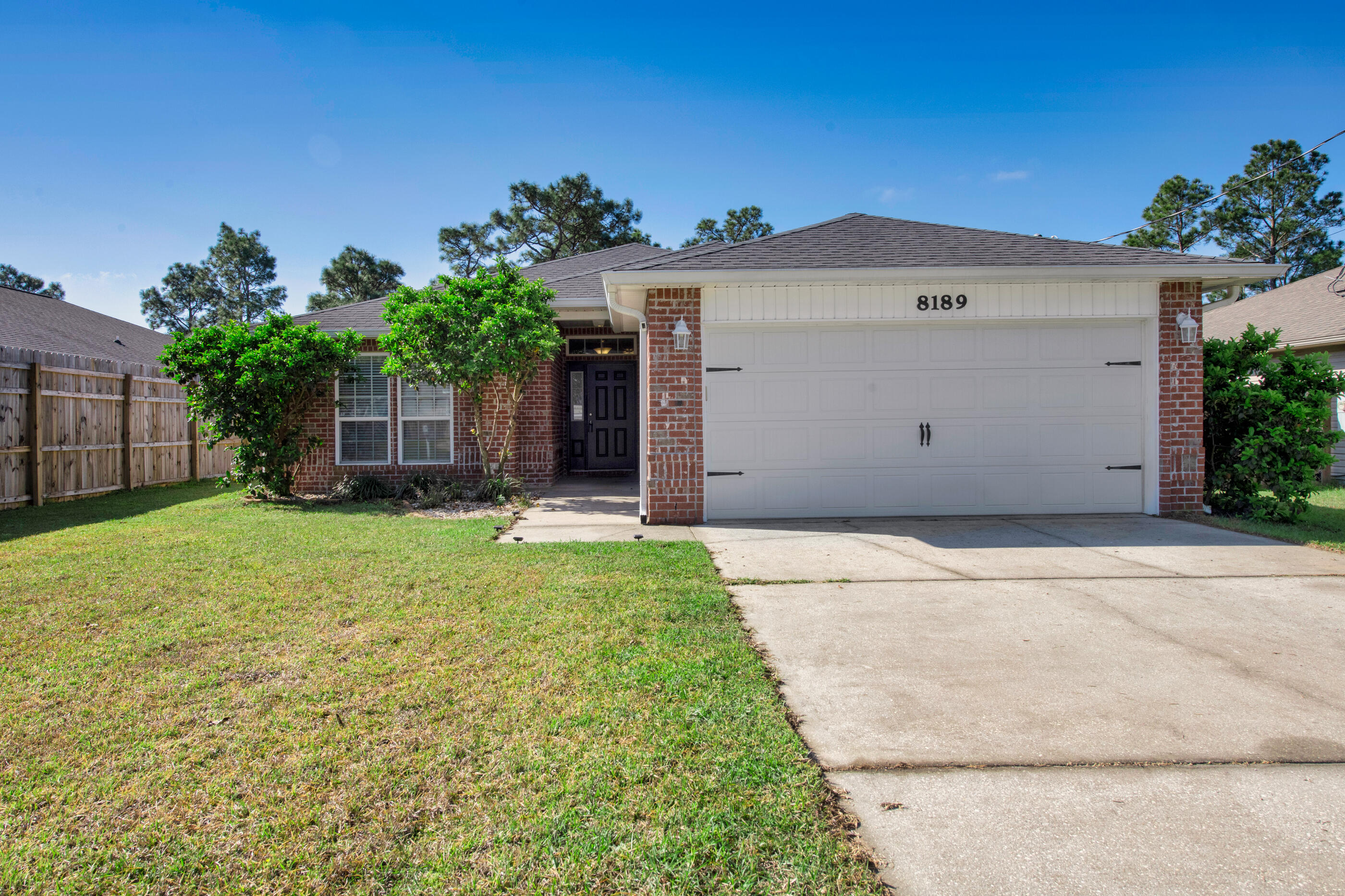 This home is IMMACULATE and ready for YOU! Step inside this 4-bedroom beauty that has long lasting, wood look tile floors and new carpet in the bedrooms. The open floor plan works for everyday living & makes a great space for entertaining. The kitchen is part of the great room and features a 12 ft breakfast bar, granite counters, island, tile backsplash, pantry and plenty of cabinet storage! This kitchen truly is the heart of the home! The spacious main suite and private bath are just right for relaxing. Wait until you see this closet! Space for more shoes! Outside, the huge backyard is fenced and divided into 2 zones for all different outdoor activities for people and pets! You'll also appreciate the newer HVAC system (2020), termite bond protection, gutters and sprinkler system! Location, location, location! Only 2 miles to the beautiful white sands of Navarre Beach, 1 mile to Publix and 13 miles to Hurlburt Field! Take the kids to Navarre Children's Splashpad and Park just down the road or the adults can hop right over to Juana's Pagoda Bar and Grille for waterfront dining. Act fast!!