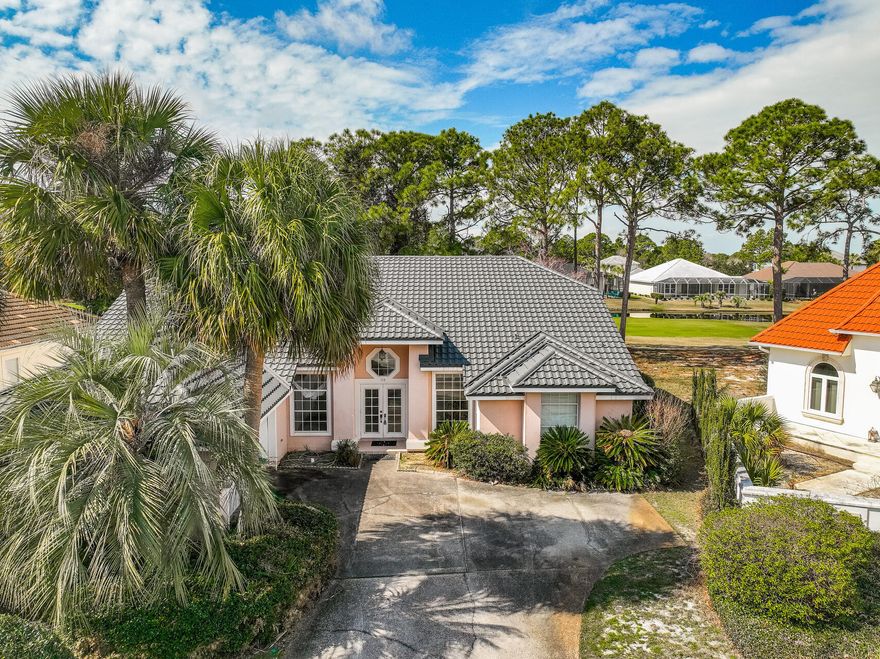 Discover an incredible opportunity to own a home in the prestigious Emerald Bay community of Destin. Situated deep on a quiet cul-de-sac along the 17th fairway, this 3BR/3BA + office residence spans 2,459 square feet and boasts stunning views of the Choctawhatchee Bay. Enjoy Florida living at its finest with a heated screened-in pool and hot tub, perfect for relaxing or entertaining year-round.While this home needs some updating, it offers great bones with spacious bedrooms, an open floor plan, abundant natural light, and established landscaping. Recent upgrades include a brand-new galvanized metal barrel tile roof, ensuring long-term durability while maintaining the aesthetic of the neighborhood. Additional features include a two-car garage and ample storage space. Located within the gated Emerald Bay Golf Club, residents enjoy access to a championship 18-hole course, a community swimming pool, two tennis courts, a guest house, and night security. The clubhouse features a full-service pro shop and a grill with a full bar and indoor/outdoor dining. Popular shopping, dining, and activities are all minutes away along with the award-winning Destin beaches.
