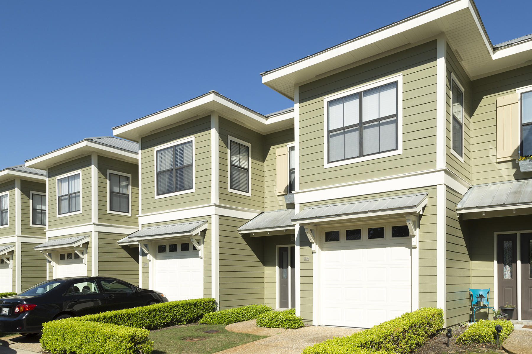 This exceptionally well-maintained unit is perfect as a 'first' home, second home near the beach, full-time living or for anyone ready to simplify and down-size! Modern industrial touches with a coastal flair are the vibes you'll feel once you step inside this welcoming three bedroom, two and a half bath town-home. Purposefully decorated with neutral colors throughout. Spacious master bedroom suite features an in-suite bath. Second floor laundry includes dryer and new washer. Tile floors in kitchen and baths. Updated, gray washed, laminate wood flooring in all main living areas. Custom designed, driftwood 'Edison' light dining fixture, upgraded industrial track kitchen lighting, all new blinds on second floor windows, new HVAC unit less than two years old. This prime location in