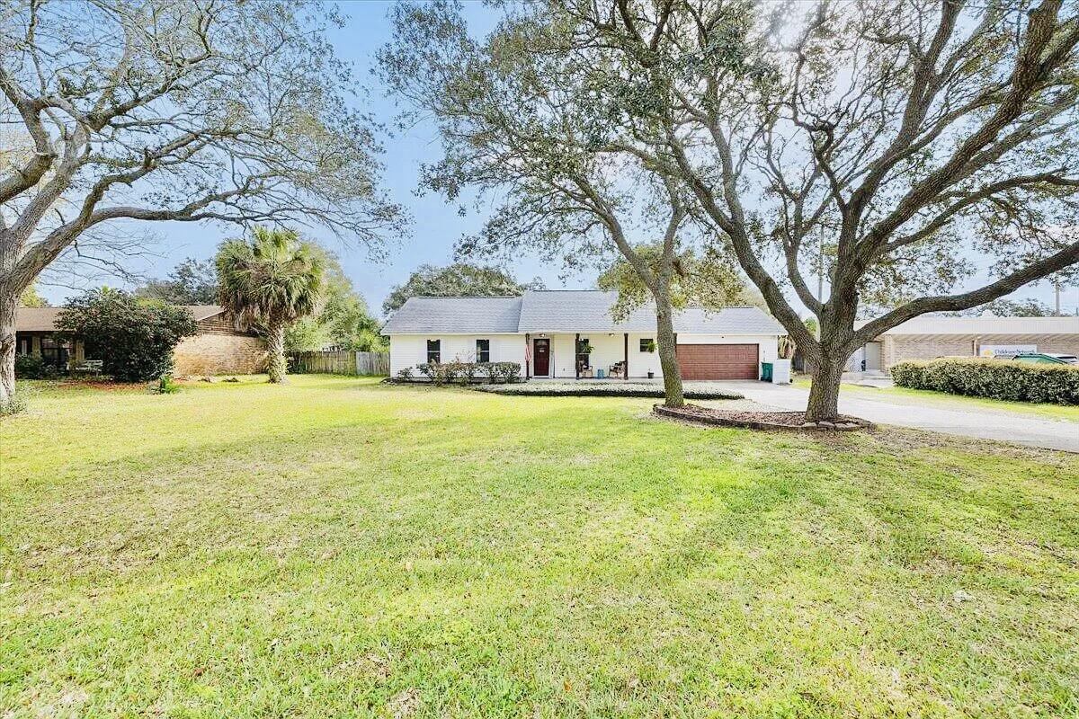 LOCATION!! HUGE LOT!! NO HOA!! $10K CONCESSION WITH FULL PRICE OFFER!This property is a MUST SEE!!! Located in the heart of Destin with NO HOA, this stunning and spacious 3 bedroom 2 bath home is the perfect blend of comfort and modern elegance. Designed with an open concept floor plan, this home offers a seamless flow between living spaces making it ideal for both everyday living and entertaining. As you enter, you're greeted by a bright and spacious living room. The expansive area is bathed in natural light and offers picturesque views of the beautiful, large and private backyard. The living room effortlessly transitions into the dining area and kitchen, creating a harmonious space for family gatherings and dinner parties. The outdoor area is not to be overlooked! This yard is a true GEM. Adorned with mature trees, such as Magnolias and Oaks, the backyard oasis is perfect for both relaxation and play. The sprinkler system makes upkeep a breeze! The nearly half acre lot features a newly stained wooden deck perfect for entertaining and grilling! You will enjoy the bonfire pit area and ample space for parking your boat, RV, trailers, ETC! There is also PLENTY of room to put a pool in! The opportunities are endless. Also worth mentioning is the LOCATION of this home! This home sits nearby to ALL your heart desires! Grocery stores (the new Publix is ONE mile away!), shopping and endless dining options! You are conveniently located nearby to schools, Joe's Bayou boat launch, city parks, the beloved Destin beaches and truly all Destin has to offer! Schedule a visit today and take the first step toward making this dream home your reality! Your perfect sanctuary awaits. 