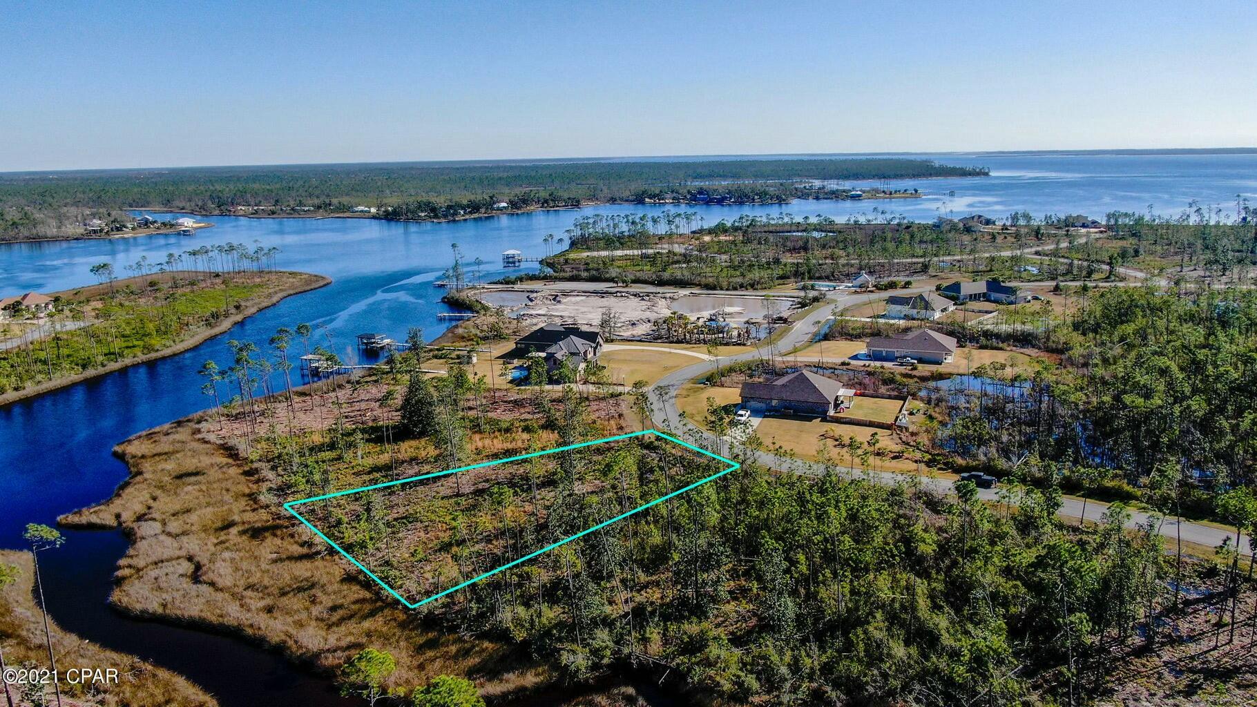 Nice waterfront lot with access to the Gulf.  Perfect to build your dream home & dock!  This lot offers incredible sunsets, fishing, bird watching, paddle boarding, kayaking, boating and more!  Just minutes from town, yet offers great redfish and speckled trout fishing!  Amenities include:  community pool, boat launch, community dock and camper/RV storage offering a nice Gulf Coast lifestyle.  Lot measurements are approximate.