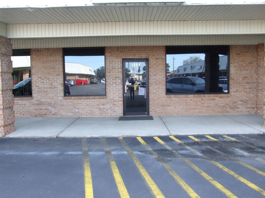 large open area in front with break room or conference room and private office behind