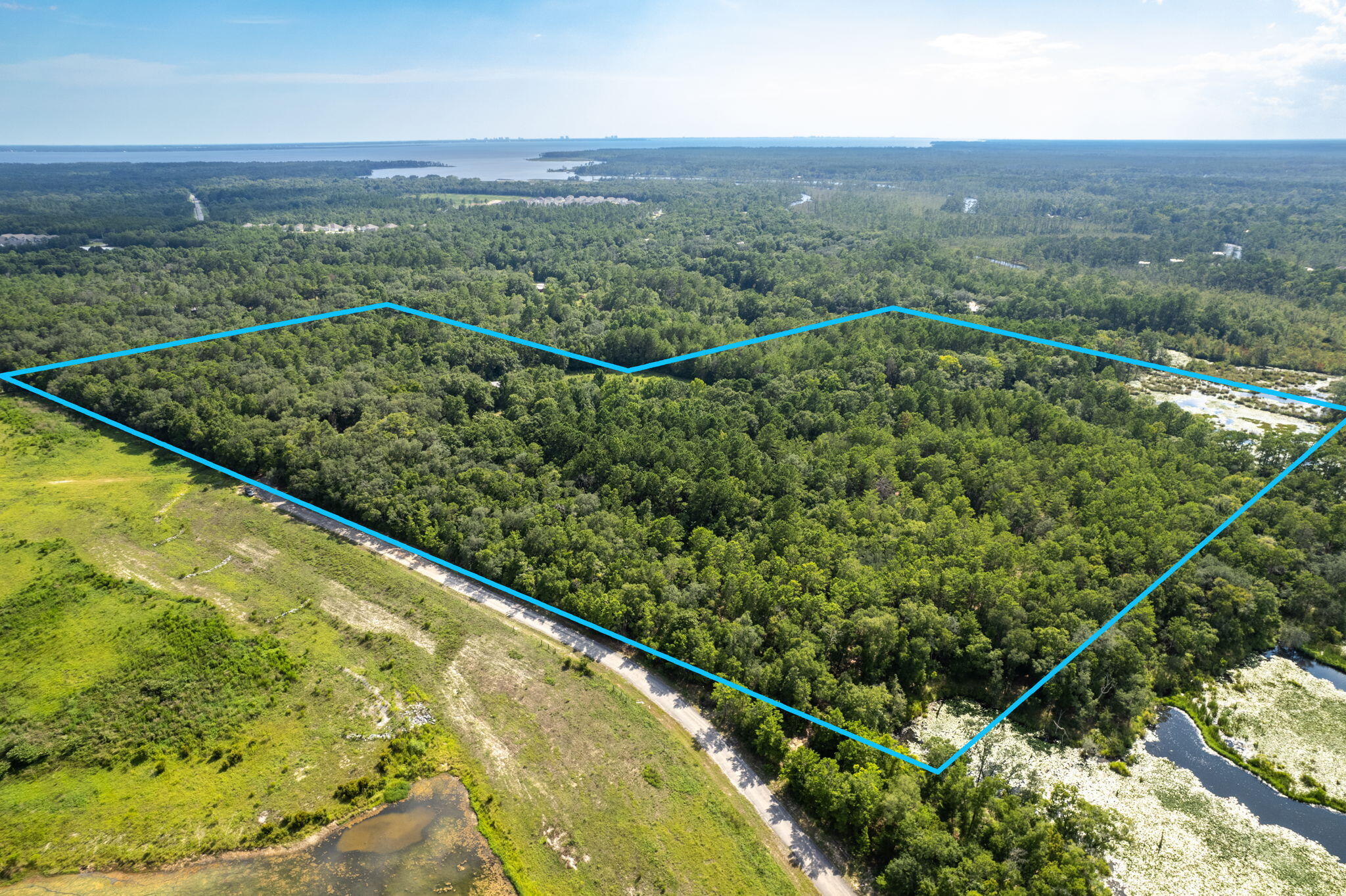 INVESTORS ALERT!   Location, location! This unique 41-acre estate offers a perfect blend of easy access and seclusion. Don't miss out on this opportunity. With a red brick home, barn, shed, well house, and natural features like a stream and mature oak trees, this property is a blank canvas for your imagination. Let your imagination run wild! This sprawling estate could be your very own secluded dream farm with livestock and crops. You may also see a charming village of rustic homes nestled around the farmland features, with the original red brick home as the welcome office. This parcel is zoned as a rural village, so two homes can be placed on one acre. Although all information is deemed correct, the Buyer should verify all information.