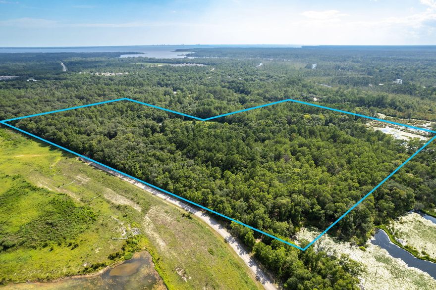 INVESTORS ALERT!   Location, location! This unique 41-acre estate offers a perfect blend of easy access and seclusion. Don't miss out on this opportunity. With a red brick home, barn, shed, well house, and natural features like a stream and mature oak trees, this property is a blank canvas for your imagination. Let your imagination run wild! This sprawling estate could be your very own secluded dream farm with livestock and crops. You may also see a charming village of rustic homes nestled around the farmland features, with the original red brick home as the welcome office. This parcel is zoned as a rural village, so two homes can be placed on one acre. Although all information is deemed correct, the Buyer should verify all information.