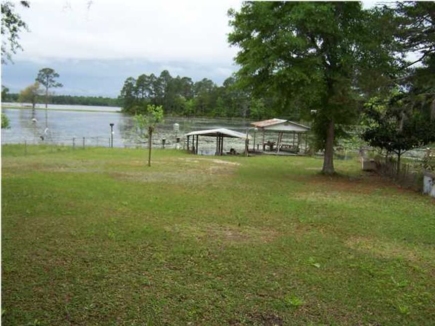 Excellent buy on this two bedroom mobile home on Juniper lake. Home is fantastic condition for its age. It has a new roof installed over the original roof and the inside has been well maintained. I has a large master bedroom. There is a laundry room built on with washer and dryer. There is a huge covered back porch across the back. There is also a nice wooded deck beside the porch overlooking the lake. The house is being sold completely furnished. It even includes the boat and the canoe in the boat house and dock. There is a 2 slip covered boat dock. Private boat ramp. There is also another covered boat dock with fish cleaning station. Home has amazing views and excellent fishing.