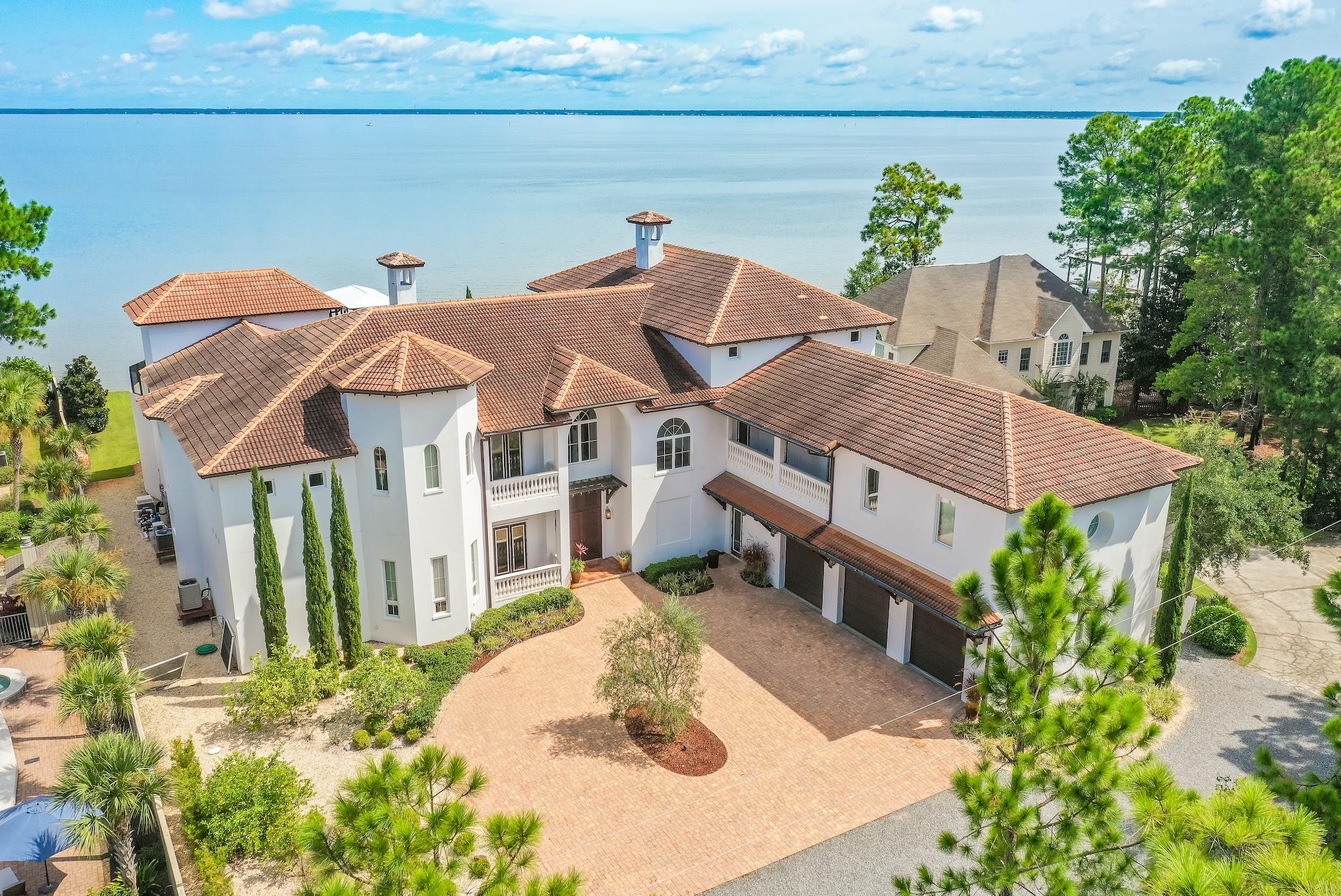 This architecturally distinct 14,000 square-foot residence takes full advantage of its bayfront location, blurring the lines between indoors and out while allowing for the most pleasurable resort-like lifestyle. The breezy outdoor spaces and light-filled, view-focused interiors offer relaxed and refined modern living.With over 130 feet of water frontage on the Choctawhatchee Bay, the property boasts a private boat lift and dock leading from the water to the estate's lavish amenities which include an outdoor kitchen, pool, hot tub, and screened-in lanai. A generous green space offers additional room for entertaining guests, family holiday celebrations or large-scale corporate events.Beyond the French doors, an open floor plan reveals expansive light filled living spaces.