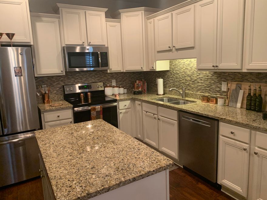 Welcome to the beautiful family friendly neighborhood of Driftwood Estates. This large subdivision is right near the bay and has sidewalks for walking, a community pool, tennis courts and a park right down the street! The immaculate home for sale has vaulted ceilings, three bedrooms plus an office and two baths.  The owners had this home built with many upgrades including gorgeous 5'' hardwood floors and tile throughout. The kitchen has Bisque colored cabinets and Venetian Gold granite countertops, as well as upgraded stainless steel appliances that give the open floor plan a light and airy feeling. Gutters were also added outside on all four sides. There is also plenty of storage space in the attic with  a pull down ladder access that was just installed.