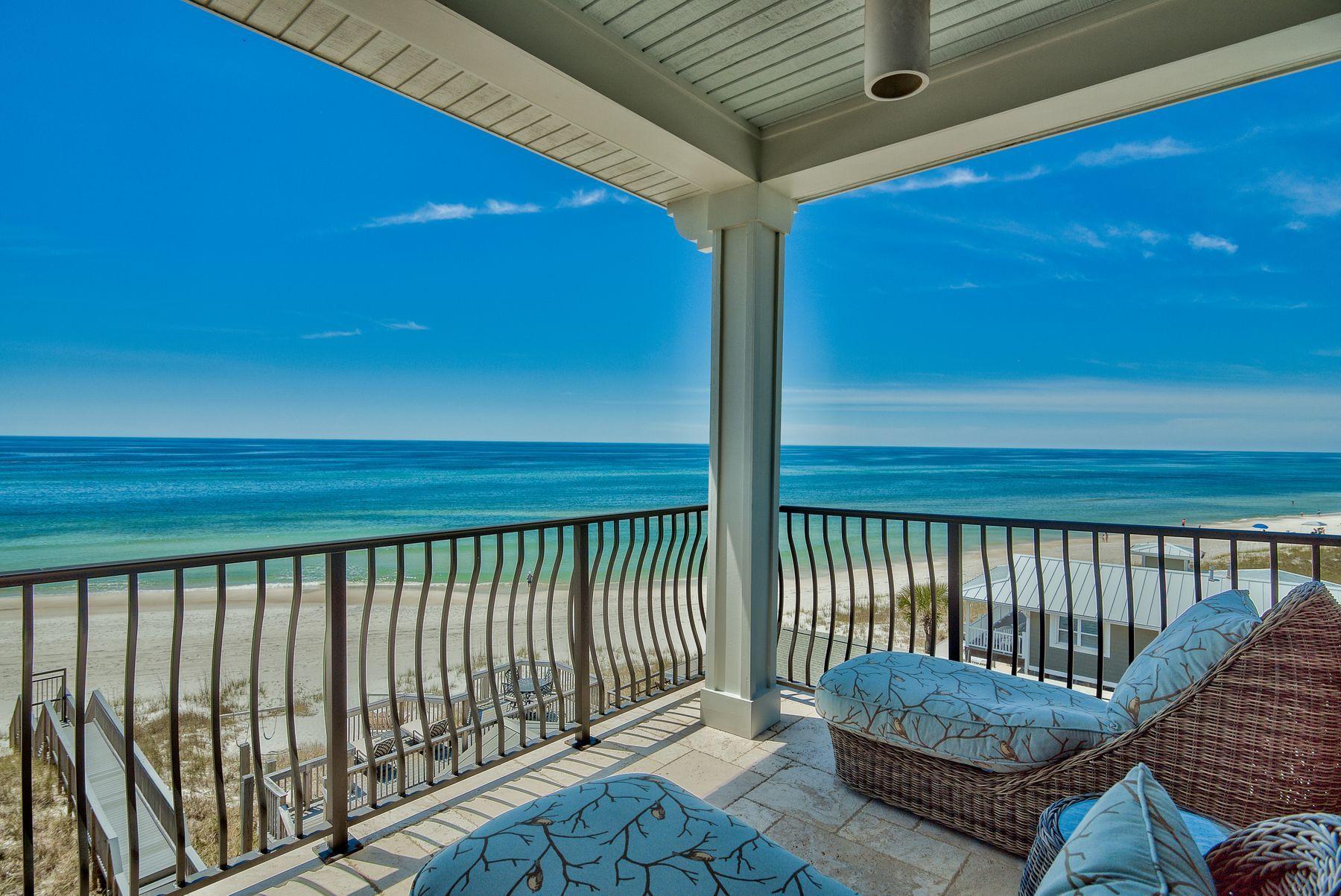 This stunning, multi-level, custom-designed home flanked by palm trees sits on the Gulf of Mexico and offers extraordinary, unobstructed views. A private beach walkover takes you to the water's edge and miles of beautiful, sugar white sandy beach. The exterior has recently been painted, and rustic interior oak floors have been reclaimed from a 100-year-old farm. Coupled with a pecky cypress inlay ceiling, these wood elements add the perfect natural flair to soft aquamarine walls with white trim. Architecturally significant features include crown molding, horizontal shiplap accent walls and ceiling, built-in shelves, an elevator and charming wine bar with wine cooler at the edge of the kitchen. Lovely white cottage cabinetry extends in front of the refrigerator, and a professional gas range