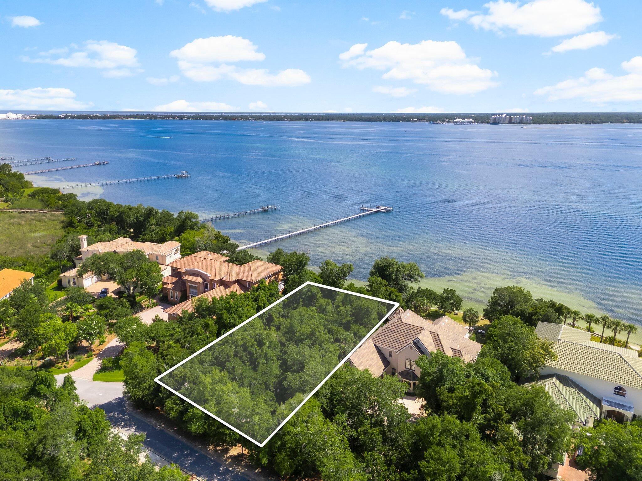 Discover a rare opportunity to own an estate-sized, waterfront lot in The Preserve on the Bay, one of Panama City Beach's gated communities. This expansive homesite, just under half an acre, offers panoramic water views and the ideal setting to build your dream home. With all utilities available and a current survey on hand, the property is ready for development. You can build your own private dock and enjoy easy access to the Gulf of Mexico, making it perfect for boating enthusiasts. Nestled in a serene, private setting surrounded by natural beauty, yet conveniently located close to the beach, top-rated schools, premier shopping, and dining, this is coastal living at its finest. Don't miss your chance to own this exceptional piece of paradise.