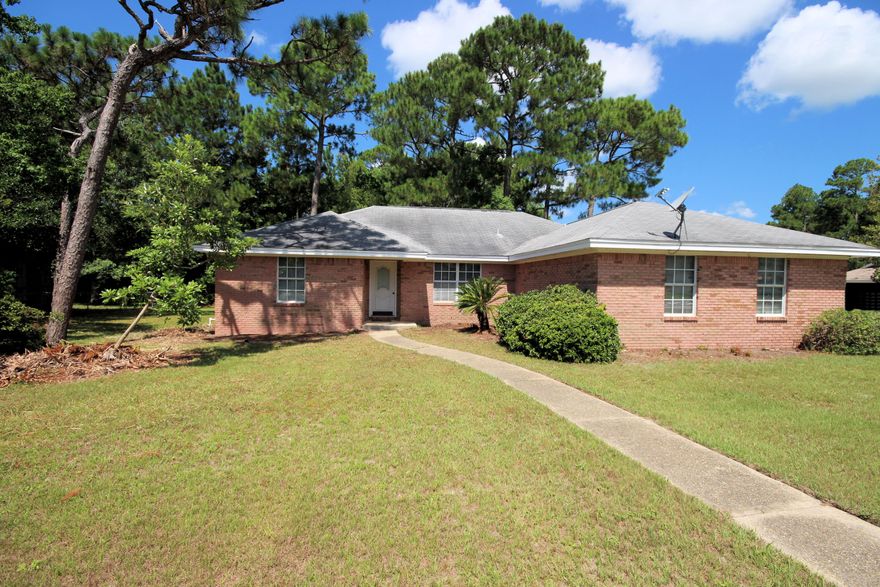 All brick home located on over a 1/4 acre corner lot with plenty of shade trees in back yard. Enter the foyer that leads to an open living room with fireplace flanked by windows facing back yard. Dining area has columns for definition yet open. Split bedroom floor plan for privacy. Eat-In-Kitchen is very large with plenty of room for the center island. Enjoy meals in the kitchen overlooking the back yard, or retreat to the New wooden deck accessible from the kitchen. Great for barbecues and gatherings. Large Master bedroom has windows facing the backyard and a very roomy master bath. Home is located west of Hurlburt Field. Convenient to Highway 98, Navarre Beach and Emerald Green waters of the Gulf of Mexico.