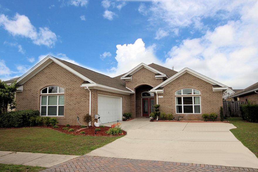 All brick contemporary style home in a gated community. This well maintained 4 bedroom/3 baths and 2 car garage home offers open floor, split bedroom plan, cathedral Ceiling, crown molding, tray ceiling, cozy gas fireplace in the living room. Master bath has whirlpool bath tub, separate shower, titled floor and double vanity. Nice tiled open porch outside, fenced back for privacy, sprinkler system. Best of all-Community Pool for hot summer days and central location! Curtains does not convey.