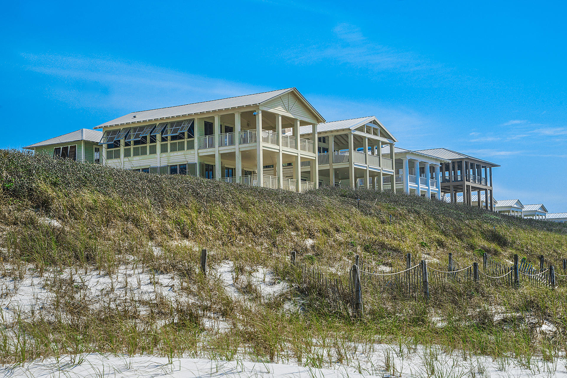 This beautiful gulf front residence, ideally located in the heart of iconic Seaside, is a must see! With its chic design elements and classic coastal look, this home embodies the 30A Life. With three floors, four bedrooms, four and a half bathrooms, an enormous amount of indoor and outdoor living space, an elevator, two laundry rooms, and of course, truly remarkable views, this property is sure to impress. The first level offers a spacious master bedroom with ensuite, large walk-in closet, and private porch access. A large bunk room, bathroom, and laundry room are also located on the first level. The second level offers a second master suite with a large private porch, a guest bedroom with ensuite, and a second laundry room. On the third level, a spacious living area opens to a