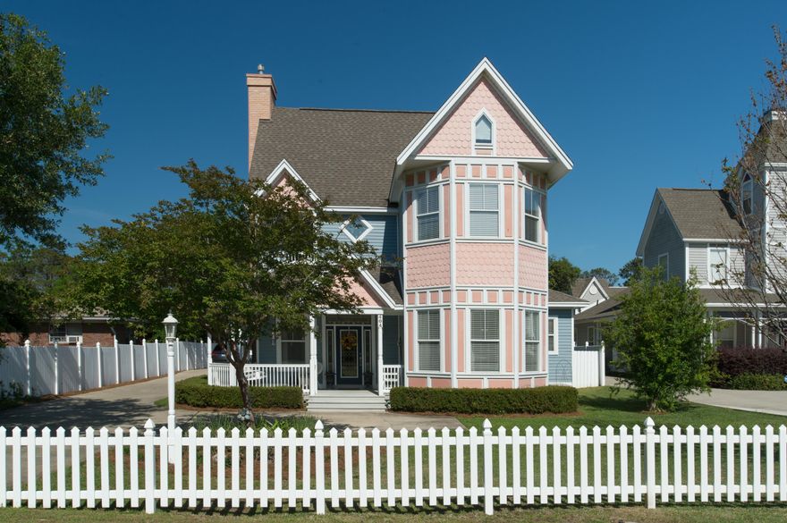 This charming Victorian inspired home with its ornate roof line, white picket fence and wrap around porch creates an inviting atmosphere. The open concept living, and kitchen provide a multi functional area perfect for the family to relax and entertain. Notable features and upgrades include, 10'ceilings, bamboo wood flooring, gas fireplace with wood and marble inlay, custom cabinetry, Corian counter tops, stainless appliances and an abundance of storage! The private yard and outdoor covered Lanai combine to form a cozy and inviting space. There is a detached 364 Sq.Ft. heated and cooled office/workshop over the 3rd Garage which makes a perfect office or He shed! If you have lots of toys boats, cars, RV there is plenty of room for parking with the added bonus of being less than one mile