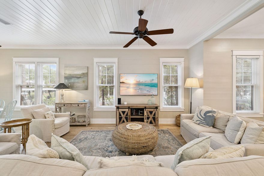 Two Blocks from Camp WaterColor this beautifully furnished four-bedroom home offers the timeless appeal of coastal design paired with modern livability. A wide front porch introduces a bright, open interior where hardwood floors flow throughout the living spaces and bedrooms. The heart of the home is its inviting kitchen, thoughtfully equipped with a farmhouse sink, granite countertops, stainless steel appliances, and a gas range ideal for family dinners or casual entertaining. With two primary suites -- one on the first floor and another upstairs overlooking the trees and backyard -- each offers a private retreat with ample closet space and spa-style baths. The additional guest rooms include a charming bunk room that makes the most of space and light. Rental Projections over $200k Outdoor living is equally compelling. A spacious screened back porch overlooks the fenced backyard, while an adjoining paver patio provides extra room for dining or relaxing under the stars. The oversized, pool-ready lot enhances the sense of privacy and potential. Practical features include parking for two vehicles and a six-seat street-legal golf cart for easy access to community amenities. Just two blocks from Camp WaterColor and a short golf-cart ride to the Beach Club, shops, dining, and Seaside, Florida, this property embodies the ease and sophistication of resort-style living in one of 30A's most sought-after communities.