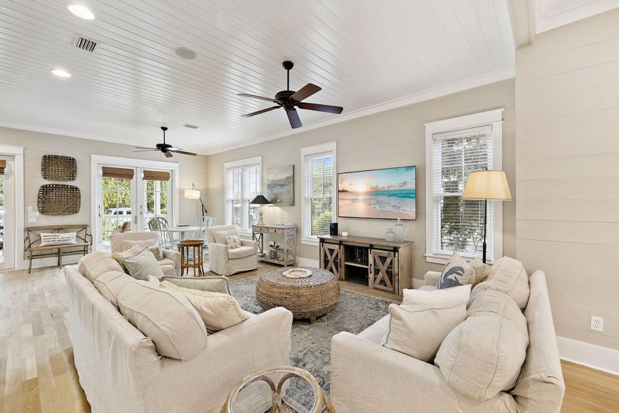 Two Blocks from Camp WaterColor this beautifully furnished four-bedroom, three-and-a-half-bath home offers the timeless appeal of coastal design paired with modern livability. A wide front porch introduces a bright, open interior where hardwood floors flow throughout the living spaces and bedrooms. The heart of the home is its inviting kitchen, thoughtfully equipped with a farmhouse sink, granite countertops, stainless steel appliances, and a gas range ideal for family dinners or casual entertaining. With two primary suites -- one conveniently located on the first floor and another upstairs -- each offers a private retreat with ample closet space and spa-style baths. The additional guest rooms include a charming bunk room that makes the most of space and light. Rental Projections over $200k Outdoor living is equally compelling. A spacious screened back porch overlooks the fenced backyard, while an adjoining paver patio provides extra room for dining or relaxing under the stars. The oversized, pool-ready lot enhances the sense of privacy and potential. Practical features include parking for two vehicles and a six-seat street-legal golf cart for easy access to community amenities. Just two blocks from Camp WaterColor and a short golf-cart ride to the Beach Club, shops, dining, and Seaside, Florida, this property embodies the ease and sophistication of resort-style living in one of 30A's most sought-after communities.