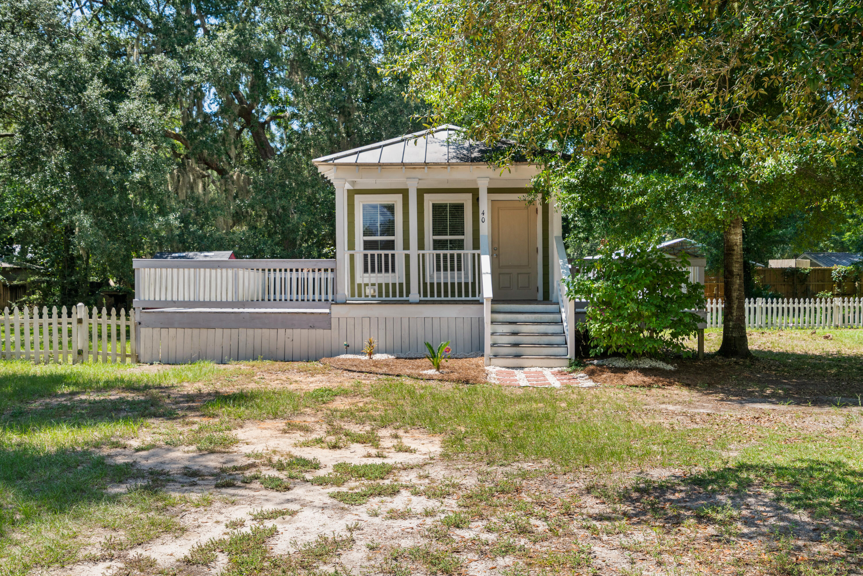Why rent when you can own? This 2 bed, 1 bath modular home sits on over half an acre just off W Hwy 83A (Bay Loop Rd) with a fenced backyard. Inside you'll find 728 sqft. of efficient living space, a spacious bath with full-size tub, washer/dryer hookups, and a bright kitchen with smooth-top stove, refrigerator, and microwave. The best part? Over 1,000 sq. ft. of porches and decking--perfect for entertaining or relaxing outdoors. A rare chance to own a move-in ready home at a price well below most in the area!