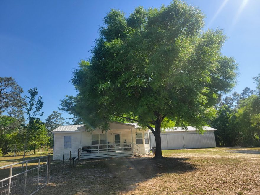 This is a sweet deal with a 3 bedroom 2 bath 2005 built manufactured home with a large 24'x48' metal, double sliding door workshop/garage with concrete floor.  Built in 2023 with a 125 amp panel box, with outlets throughout.  Home has new laminated floors with roomy kitchen and adjoining dining room.  Large living room for all of the family.  Located on almost an acre (.95),  partially fenced. Just 1 mile north of Hwy 90 W off  Hwy 331 N near Chelco. New roof and water heater installed in 2017.  Only 45 minutes to the South Walton Beaches and Crestview 30 minutes west.   If you need a nice updated home with 864 s.f. metal storage garage/building then check this out!