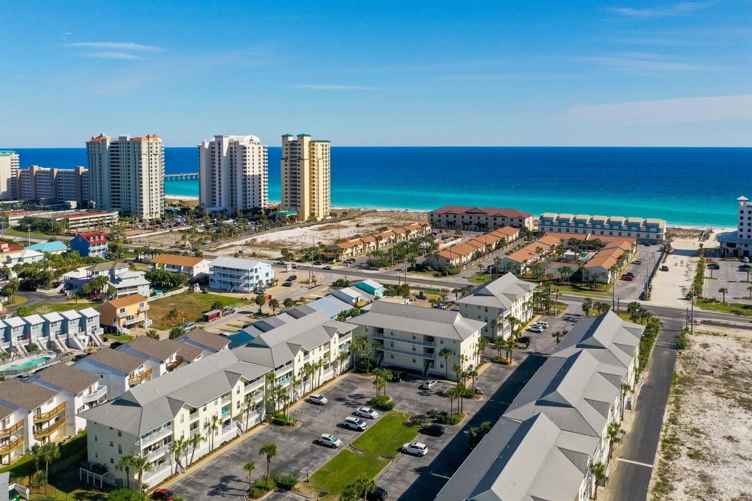 Ocean breezes and iconic sugar white sands await you ~ all while enjoying the balcony views of the Gulf and Navarre Pier from this top floor end unit. This completely furnished condo has fresh and trending finishes with upgraded wide-slat plantation shutters on all windows.A recent renovation included washed-wood look PLV flooring throughout; granite countertops; and high end lighting fixtures. Main rooms feature light/combo ceiling fans.Gulf Island Condominiums grounds are meticulously kept and boasts a year round private heated swimming pool for the residents.The main bedroom sits just off the living room with an ensuite bathroom; full bath and shower and private sliding glass doors onto the balcony; allowing you to enjoy cool evening ocean breezes and glorious morning sunrises. The 2nd bedroom and 3rd bedrooms sit off the main hallway; both spacious and with large closet space with shelving. Both  access the 2nd bathroom with full bath/shower and vanity. 
A laundry room with washer and dryer combo is across from these bedrooms with plenty of hanging space for beach towels and more!
Fall in love with this bright and fresh kitchen, bright white cabinets and marbled granite countertops show off the stainless steel appliances. A separate pantry with full shelving allows for additional storage.
You'll love the privacy of this upper level corner unit; from the views to the easy access of both the gulf beach on one side to the sound beach on the other side. Short walking distance to restaurants, coffee carts and shopping make this an ideal getaway destination.