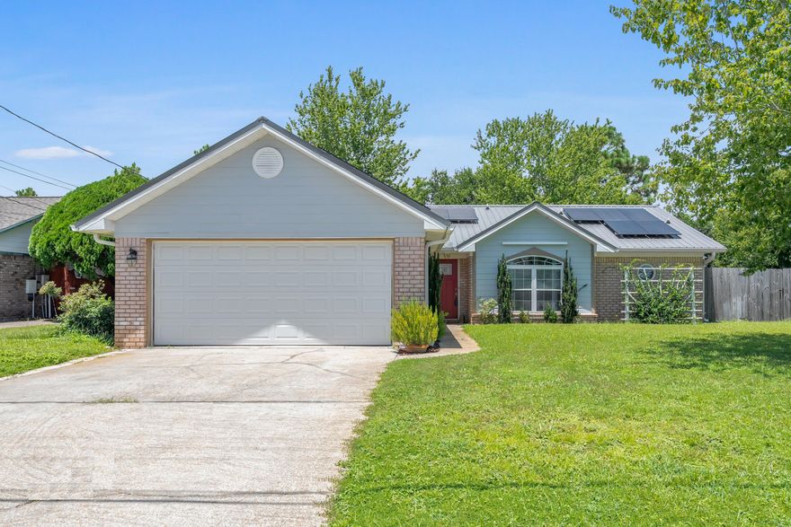 Sellers will pay off solar panels with an acceptable, full price offer. This Beautifully Maintained, All-Brick home with 2018 Metal Roof is Located Conveniently  just 8 miles west of Hurlburt, 3.5 miles East of the Navarre Beach bridge and only one block from the Navarre Wal-Mart! Close to Beaches, Bases and Shopping!  This home has been updated throughout with low-maintenance, quality tile. The eat-in kitchen is loaded with New Wood High-Quality Cabinets with dovetailed drawers and soft close doors, 2 Pantries & Durable/Attractive Recycled Glass Counter-tops!  The flat, glass-top stove/oven and premium range hood have been updated, as well as, the extra-deep sink and quality faucet. Both Bathrooms have been recently remodeled.  Because the breakfast nook is large enough for an oversized table, the formal dining room can also be used as an office or formal Living room. The great room has a beautiful brick fireplace and plenty of wall space to fit even the largest entertainment unit. The Master Bath features double vanities and double walk-in closets! The split floor plan is convenient for privacy and the extra bedrooms are generously sized. The lighting and fixtures have all been updated! The laundry room is located inside and measures 6x7. In 2016, 'Fabric Shield' Hurricane shutters were installed.  HVAC was new in 2020 with an anti-microbial UV Light!  Newer Solar Panels provide a SUPER LOW power Bill of approx $180/mth that goes towards the payment on the transferrable Solar Panel contract. Sellers will either pay off the solar panels with an acceptable, full price offer, or they will reduce the price if Buyer prefers to assume the solar loan.  There is a large, privacy-fenced back yard with a lawn pump.  The whole neighborhood has sidewalks and multiple cul-de-sacs for safe & easy walking/bike riding. This immaculate home is a pleasure to view! This is a fantastic home! Call to see it today!  