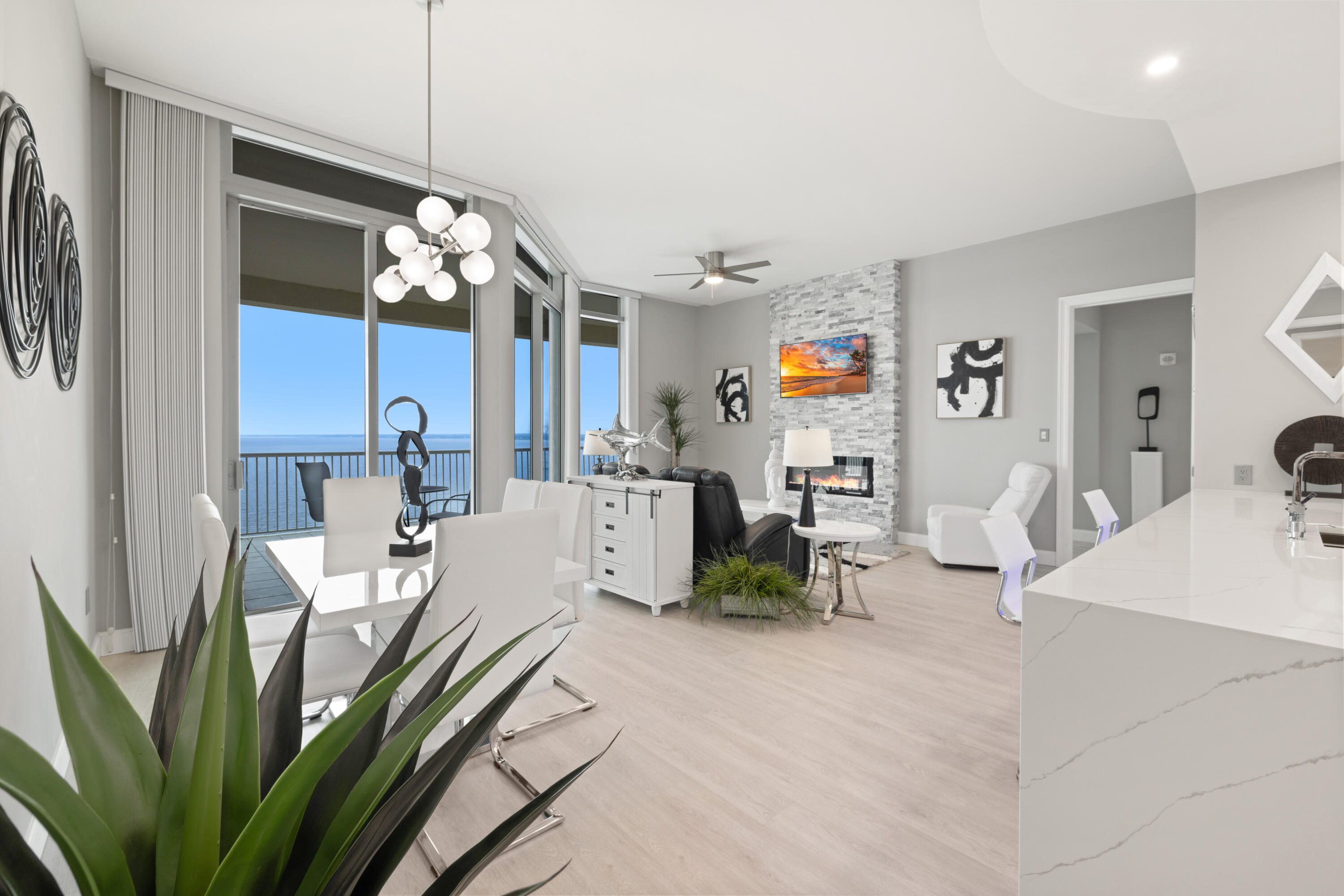 SOPHISTICATED ELEGANCE. Simply beautiful and refined. These are a few of the words you will see and feel as you view this one-of-a-kind renovated LUXURY Condo with spectacular bayfront water views! Paradise awaits you! Ultra-modern 2/2 at the desirable Marina Landing. Fully Furnished and Turn-Key Ready for you! Two Master Suites with water views and private access to the spacious balcony. The unit offers a split floor plan for privacy and both bedrooms have private en suite. Fabulous new (2021) luxury vinyl plank flooring throughout is perfect with the soaring 8 foot doors and 12 foot windows. Newly renovated kitchen (2021) with European-style, modern white glossy soft close cabinets, quartz countertops with waterfall island, undermount stainless sink and stack stone finish at the the breakfast bar wall that matches the custom-built floor to ceiling stack stone entertainment center that features a flat screen TV along with an electric fireplace! You will love the tranquil ambiance of the fireplace that flows beautifully with the undermount ambient blue LED lighting in the kitchen for that perfect soft lighting and relaxing setting. New twin mattresses (2023), all new appliances (2021) including the front-loading washer/dryer set, and beverage fridge. Kitchen also has a separate pantry. Peaceful split bedrooms equipped with walk-in closets and custom shelving. New a/c system (2021) including the rooftop exterior air handler. Massive waterfront balcony floor to ceiling sliding glass leading out to your oversized terrace with gorgeous water views from EVERY room. There is also a new grill located on the balcony. The jaw dropping luxury features of this condo are numerous ... the bathrooms are high end with vessel dual vanity sinks, glass door showers with rain head showerhead and separate shower wand. This lovely condo truly makes you feel like you have entered a spa resort. Marina Landing has a private deep-water marina onsite, and it is just minutes to the pass...perfect for boat owners desiring quick and easy access to the Gulf. There is also a beautiful Bay front pool, hot tub, a conference room, and exercise room. Exterior owner storage closet down the walkway and a designated assigned parking space (#41) included! Come view this amazing condo today!