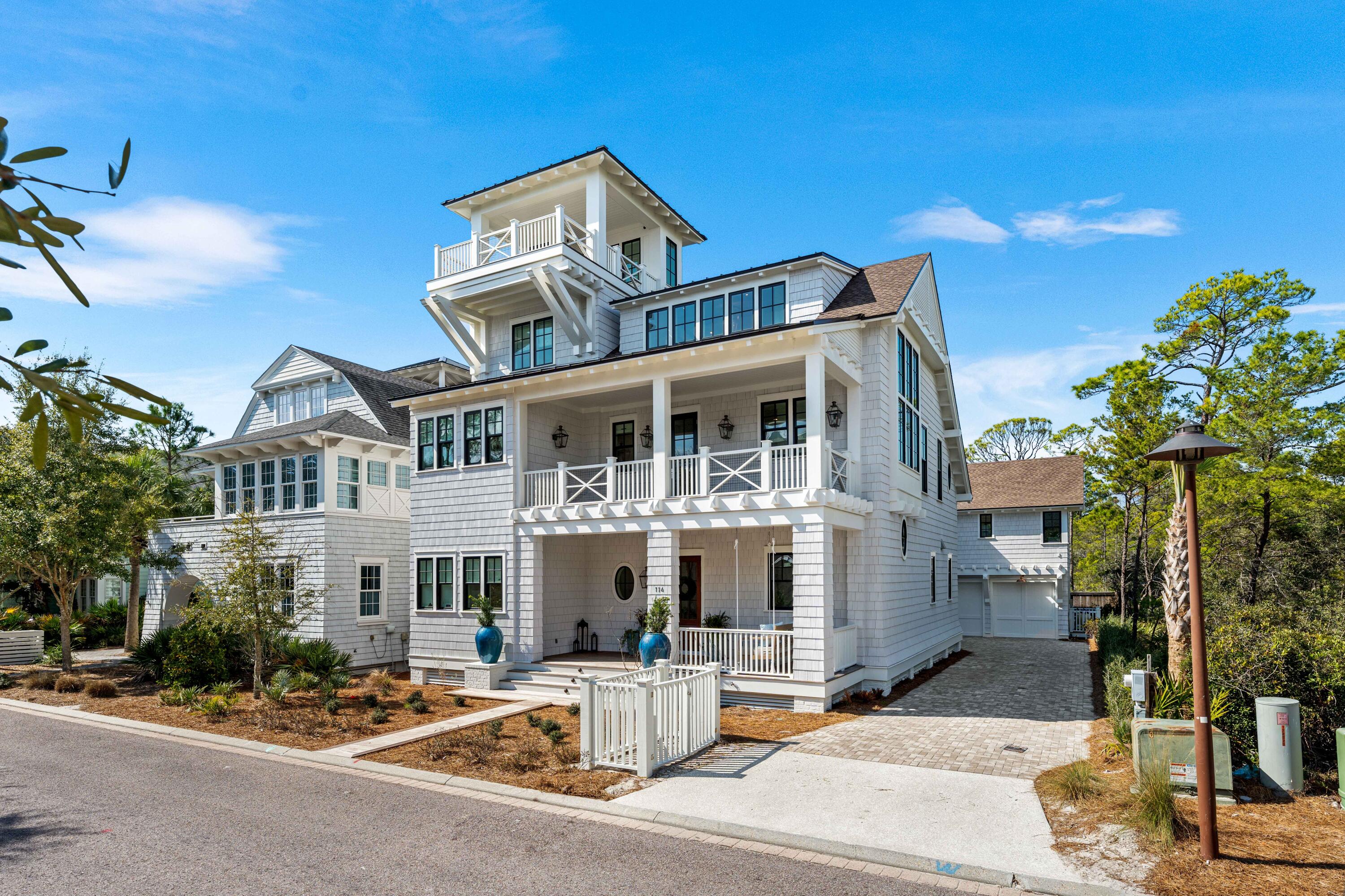 Embrace a life of casual elegance at this stunning new construction home in the community of WaterSound Beach. Spanning an impressive 4,501 square feet, this stately residence encompasses a 5BR/5.5BA primary home, 1BR/1BA carriage, a 2-car garage, a Gulf view tower, and a private pool with outdoor powder bath and shower.  The home blends coastal sophistication and impeccable design while offering a lifestyle of unmatched comfort and refinement. On the main level, the open-concept kitchen and living area are complemented by a spacious sand room with laundry and a convenient half bath. A junior master suite with an ensuite bathroom featuring dual vanities and a walk-in shower completes this floor. Fine finishes including white oak hardwood floors, custom millwork, quartz countertops, coffered and beamed ceilings, intricate tile work, designer light fixtures, and much more are incorporated into every element in the home design. With an elevator accessing the first three levels, this home offers accessibility along with style and convenience. Step outside through sliding doors from the living room to a large, covered porch where the luxury continues with a summer kitchen, heated pool adorned with water features and sun shelf, an outdoor fireplace, plus a half bath. The inviting outdoor shower is perfect after a day at the beach. 
The second floor showcases two exquisite primary suites, each with spa-like ensuite bathrooms, dual vanities, and generous walk-in closets. The main primary suite features a spacious private porch with serene views of the pool and state park, providing a personal oasis within the home. This level also offers a main laundry room, thoughtfully designed with custom cabinetry and sink, as well as an additional guest suite with ensuite bathroom.
Ascend to the third floor for a secondary living area equipped with a beverage center complete with a sink and Sub-Zero refrigeratorperfect for entertaining. A spacious bunk room with double bunks and a full bathroom make this level ideal for hosting family and friends. The crowning fourth-floor tower, with both covered and open spaces, provides breathtaking panoramic views of the Gulf of Mexico, creating a setting for unforgettable sunrises and sunsets. Adding to the allure is a private carriage house, featuring a full kitchen, bedroom, bathroom with dual vanities, living area and a Juliet balcony overlooking the tranquil state park.
The gated WaterSound Beach community is located south of Scenic Highway 30A offering homeowners a rare sense of seclusion yet with easy access to area activities. Amenities include swimming pools, a puttering park, community green spaces, a state-of-the-art fitness center, and private boardwalks to one of the most beautiful mile stretches of coastline in the area. Embrace unparalleled coastal living in WaterSound Beachyour sanctuary awaits!
