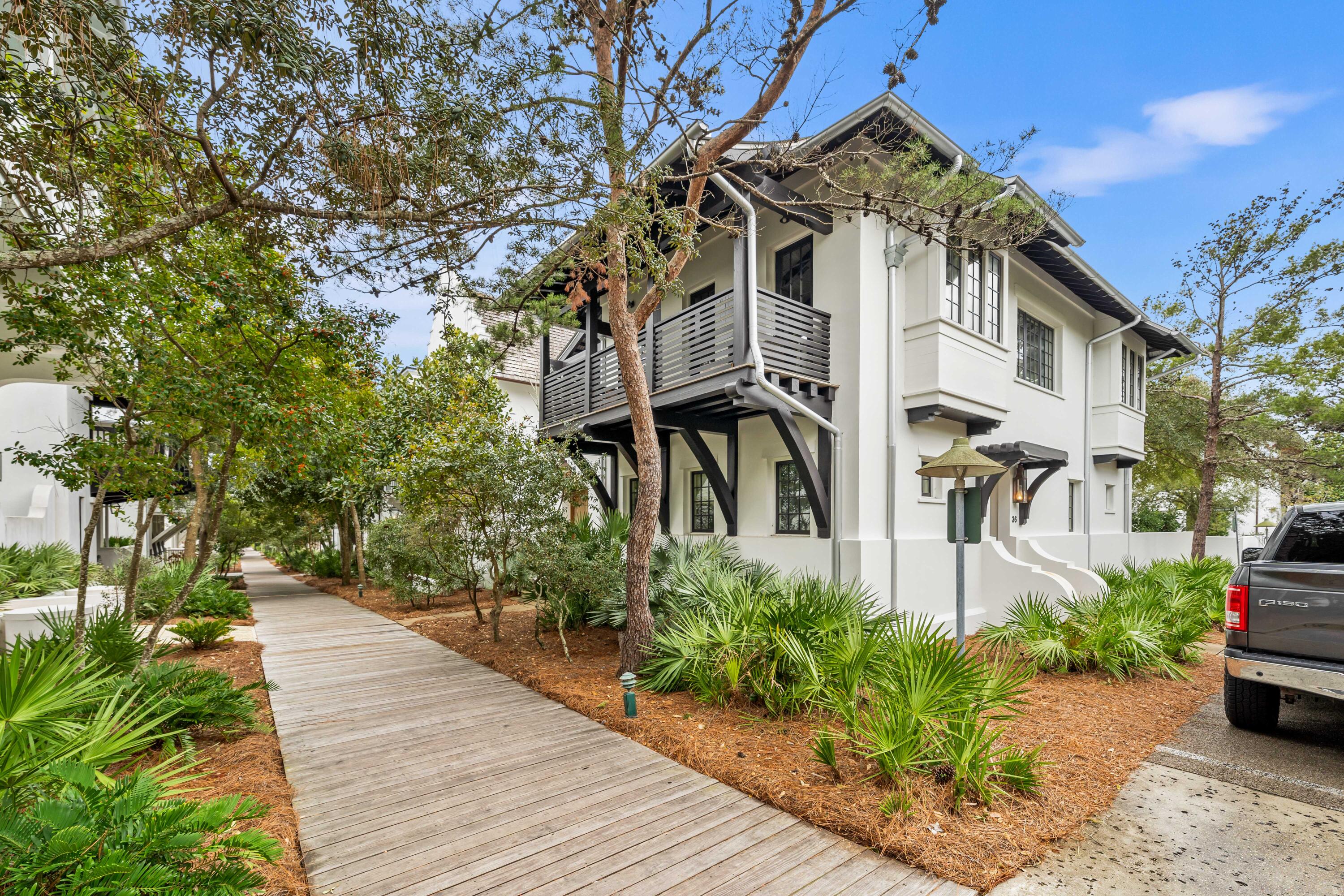 Discover the ultimate beachside retreat in Rosemary Beach! Nestled perfectly south of 30A, this home is a stone's throw away from the charming town center and just around the corner from the Barbados pool. It's a beach lover's dream, with a boardwalk leading to the pristine white sandy beaches of the Gulf of Mexico.This cozy abode features 3 full bedrooms (two are on the first level) and 3 full baths, providing ample space for relaxation and privacy. Step into your own oasis with a private courtyard, perfect for unwinding after a day in the sun. Upstairs, enjoy the wood beam cathedral ceiling that spans the kitchen, living, and dining areas, along with an expansive covered balcony, offering a serene spot to take in the coastal breeze.   MORE The heart of the home is the open and light-filled living space. Stained concrete floors on the first level create a cool and beachy atmosphere, while upstairs boasts elegant wood floors. The kitchen is a culinary haven, and the covered balcony off it is ideal for dining alfresco - a perfect setting for entertaining friends and family.
Parking is a breeze with the convenience of a carport, and the open entertaining area above adds a touch of coastal charm. Embrace the beach lifestyle in this meticulously placed home that captures the essence of coastal living without compromise. Don't miss the chance to make this Rosemary Beach retreat your own! Please verify any information, including but not limited to square footage, that may be important to you.