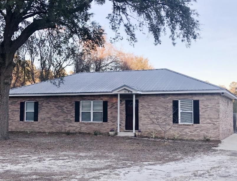 Beautiful all brick, 3 bedroom, 3 full bath home with Galvalume Metal roof, on nearly 3 acres. Backs up to Eglin Reservation. 20x40 Pole barn/Carport for 3 cars, with metal roof, easily converted to garage. Large, dried in storage shed/work shop, plus another foam insulated storage room with hardie board siding. Fully fenced in lot. Shooting range. Chicken coop with plenty of room for your chickens. RV hook up. Separate well and well house. Beautiful, high end finishes inside custom, split floor plan home with vaulted ceilings, gorgeous hand laid travertine tile, screened porch. Gunite pool with cool deck. Hunt behind you with a permit from Eglin AFB. Too much to list. Private, yet convenient to everything!
