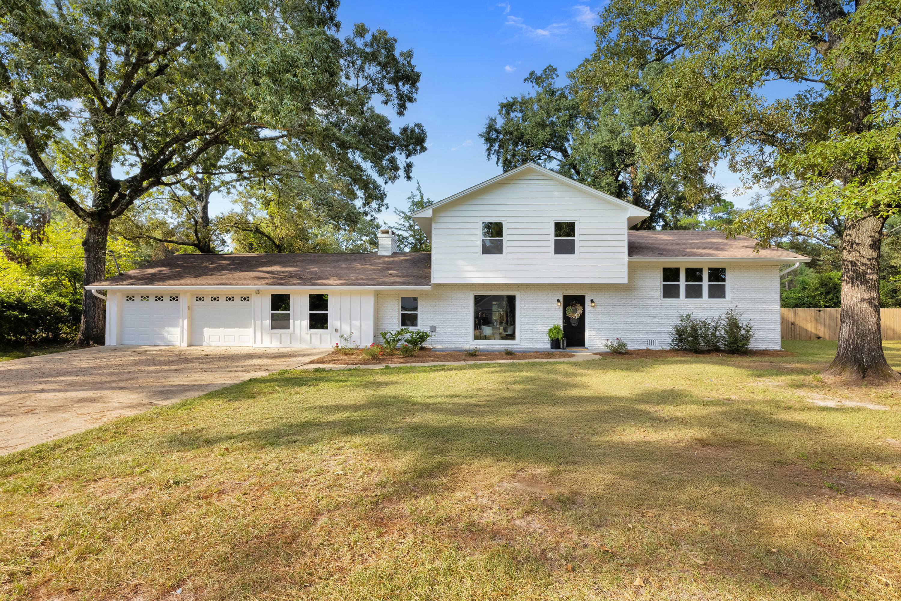 This stunning home was taken down to the studs and rebuilt with high-quality upgrades throughout in 2022. Renovations include a new roof, windows, HVAC system, exterior paint, sod, garage doors, sheetrock. Inside, you'll find white shaker-style cabinets, granite countertops, luxury vinyl plank flooring, and a fiberglass soaking tub with a granite shower in the master suite.A covered sunroom (not counted in the 2,400+ sq. ft. of heated and cooled space) adds extra room for entertaining or relaxing. In 2025, the home received fresh paint and new flooring, ensuring it feels brand new. The layout features both a formal living room and a cozy family room, along with a spa-like master bath offering a granite walk-in shower, tiled floors, and a garden tub retreat. The oversized garage with two doors provides plenty of room for vehicles, storage, or even a workshop. Home sits on 0.63-acre lot with mature trees, native azaleas, and flowering bushes. The backyard is fully privacy fenced, perfect for pets, kids, or enjoying your own outdoor oasis.