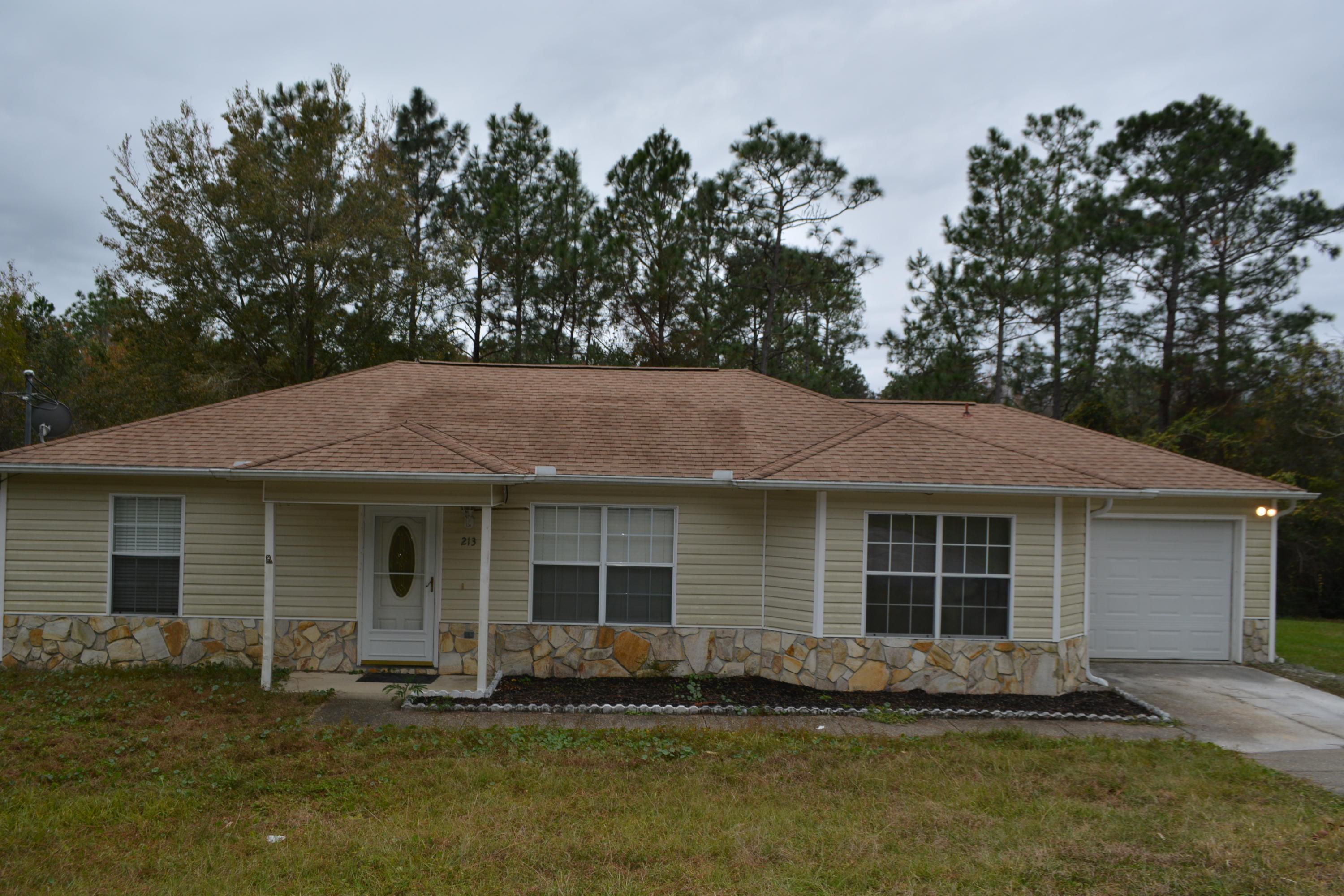 Located South of I-10 & on a cul-de-sac! Looking for a LARGE LOT but still close to all the city amenities? This home is for you! Home sits on a 1/2 ACRE LOT & backs up to woods for extra privacy! The Living Room has CATHEDRAL CEILINGS & WOOD LAMINATE FLOORING. The Kitchen has plenty of OAK STAINED CABINETRY and ample Counter Space. SPLIT BEDROOM PLAN for extra privacy. All bedrooms have ceiling fans & cable hookups. Additional bedroom to the right has BUILT IN SHELVING & CROWN MOLDING. Master bedroom has TREY CEILINGS. Master bath has a NEWLY TILED SHOWER & a LARGE WALK-IN CLOSET. There are FRENCH DOORS off Dining Room leading out to SCREENED PORCH which is great for relaxing/entertaining! INDOOR UTILITY ROOM. 1 CAR ATTACHED GARAGE w/AUTO DOOR OPENER. Call for more information!