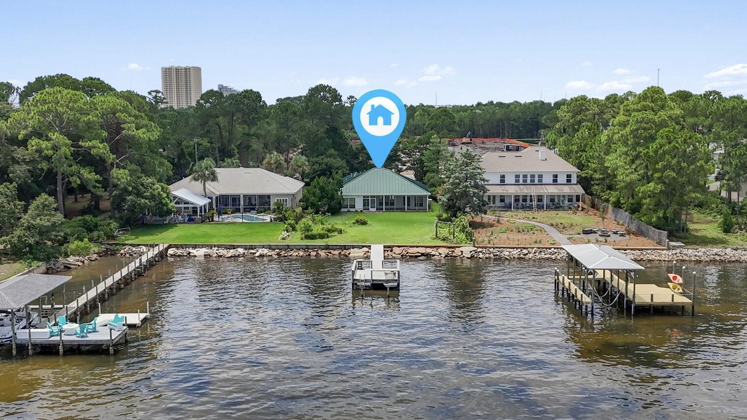 Waterfront Living in Miramar Beach - No HOA & Endless Potential! Bring your golf cart and discover the rare opportunity to own a bayfront home in the heart of Miramar Beach with 78 feet of private Choctawhatchee Bay frontage and a private dock! This location is perfect for boating, paddleboarding, fishing, or simply soaking in the serene bay views where the sunrise and sunset will take your breath away and watching dolphins play never gets old! Situated on a generous 0.51-acre lot, this single-story, 3-bedroom, 2-bathroom home offers 2,122 square feet of living space and the chance to transform it into your dream coastal retreat. Built in 1995, the home features a spacious split floor plan layout, a metal roof, a long paver driveway with additional parking, and a 2-car garage - all tucked away on a dead end street with no HOA restrictions and golf cart/LSV accessible to the beach! Inside you'll find a great layout with incredible views that's ready for your personal touch and updates. The lot provides ample space for outdoor living additions like a pool, fire pit, or expanded patio overlooking the bay. Located walking distance from Legion Park, which is slated for exciting new renovations and amenities to start at the end of 2025, this property is close to shopping, dining, and the sugar-white beaches that make Miramar Beach a destination favorite. Whether you're looking for a primary residence, vacation home, or investment with future potential, this bayfront gem offers the perfect canvas.