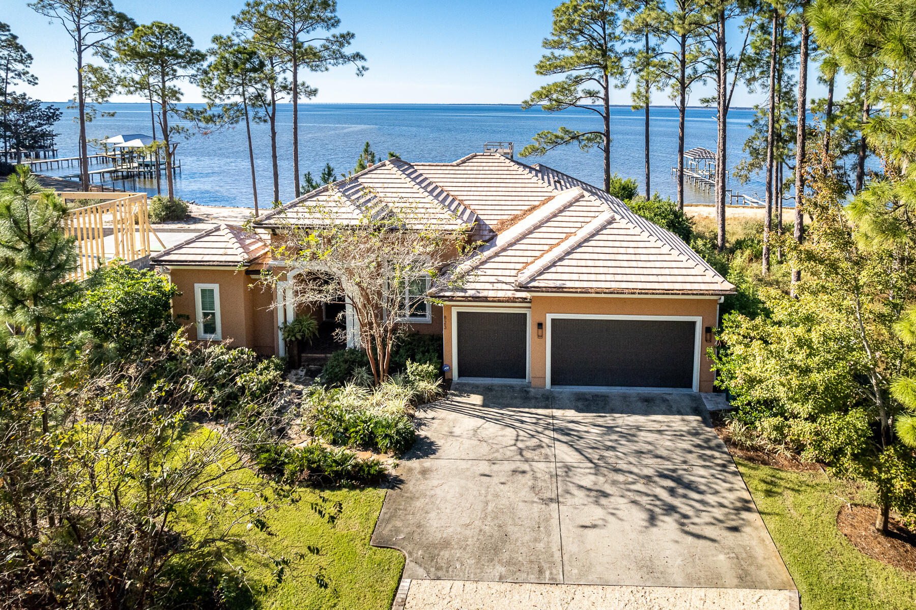 Bayfront living conveniently packaged in this charming, immaculate, manageably-sized estate home. Only minutes from Sandestin Resort and Grand Boulevard shops and dining, Driftwood Point Road is a renowned area for Bayfront living. This custom Arthur Rutenberg (Coquina Model) waterfront home has a stunning western facing view of the Choctawhatchee Bay and is perfect for someone looking to enjoy both indoor/outdoor living and year-round sunsets. Those breathtaking views invite visitors from the dramatic wood and glass front doors all the way through the fully retractable glass patio doors. Offering designer modern furnishings (included), custom features, and plenty of space, this home is perfect for entertaining.