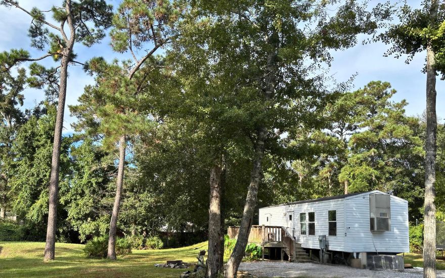 Mobile home and lot is being sold ''as is''. This compact and affordable non HOA property has city water  and septic in place.. If you are looking for a  lot for a starter home or investment property- this is your property. Serious inquiries only.