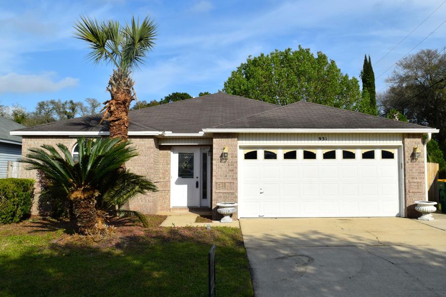Open concept with beautiful travertine in greatroom and tile floors throughout except for carpet in the front bedroom. Living room features a fireplace with wood mantle and cathedral ceilings with plant ledges. Kitchen is spacious and has warm glazed cabinets, breakfast bar and pantry. Laundry room off kitchen has shelving, cabinets and counter space. Garage includes cabinets and work space. Back covered patio is great for entertaining. Fenced yard around this corner lot includes gate for boat storage. Seller providing one year home warranty.