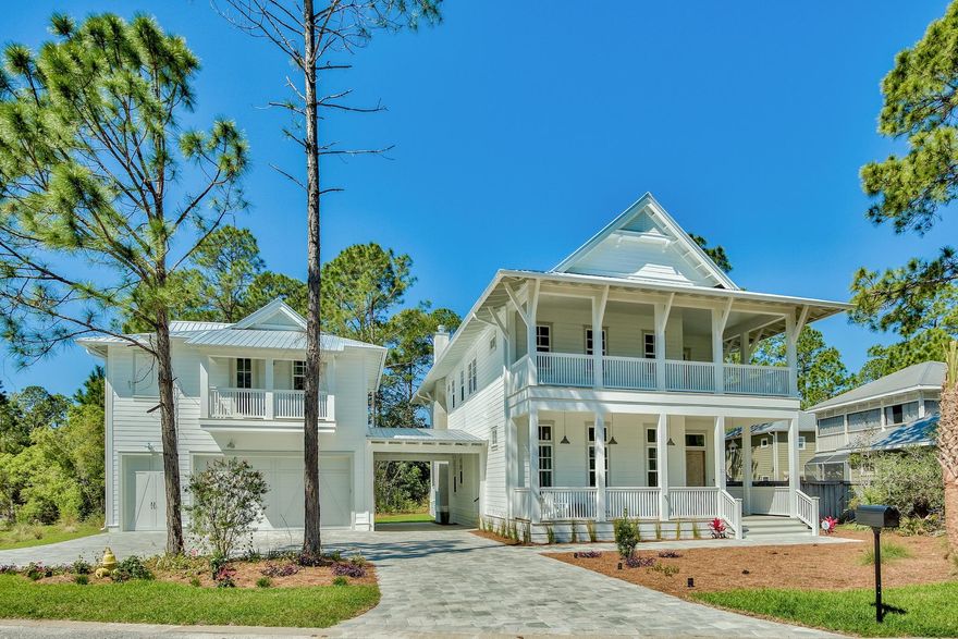 One of the most thoughtfully laid out and beautifully finished homes on 30A. 215 Wood Beach Rd owners built with privacy, detail, and functionality in mind. Situated on a large lot, off the beaten path in Seagrove, this residence offers you quiet seclusion, while still being just a short bike ride to all the entertainment of Seagrove, Seaside, and Watercolor. And it's only a 5 min walk to the beach!Upon entering the main house through the hand-carved wood French doors, you immediately notice the spacious open feel enhanced by 12ft ceilings throughout. The oversized open concept living, dining, and kitchen area flows effortlessly to the main outdoor space, through the French doors that line the back of the home. You can enjoy the ocean breezes and incredible Florida sunsets overlooking the enclosed saltwater heated pool which backs up to a non-buildable green space providing great privacy and a peaceful relaxing atmosphere. Off the kitchen, and through the mudroom, you will cross the home's open carport to the carriage house. A large 2 bedroom, 2 bath carriage house, complete with a living area, fully equipped kitchen, and laundry facilities, sits atop the oversized 2 1/2 car climate-controlled garage.  

Other notable finishes and features of the home include the Viking range and side by side Electrolux refrigerator/freezer, oversized quartz island, wine cooler and wet bar, shiplap accents, marble baths, digital shower systems, and a media room with a 70" TV. Built with energy efficiency as a priority, 215 Wood Beach Rd contains Bella spray foam insulation, a Bosch high efficiency A/C unit, and high impact windows and doors. The home will be sold fully furnished, excluding artwork.  