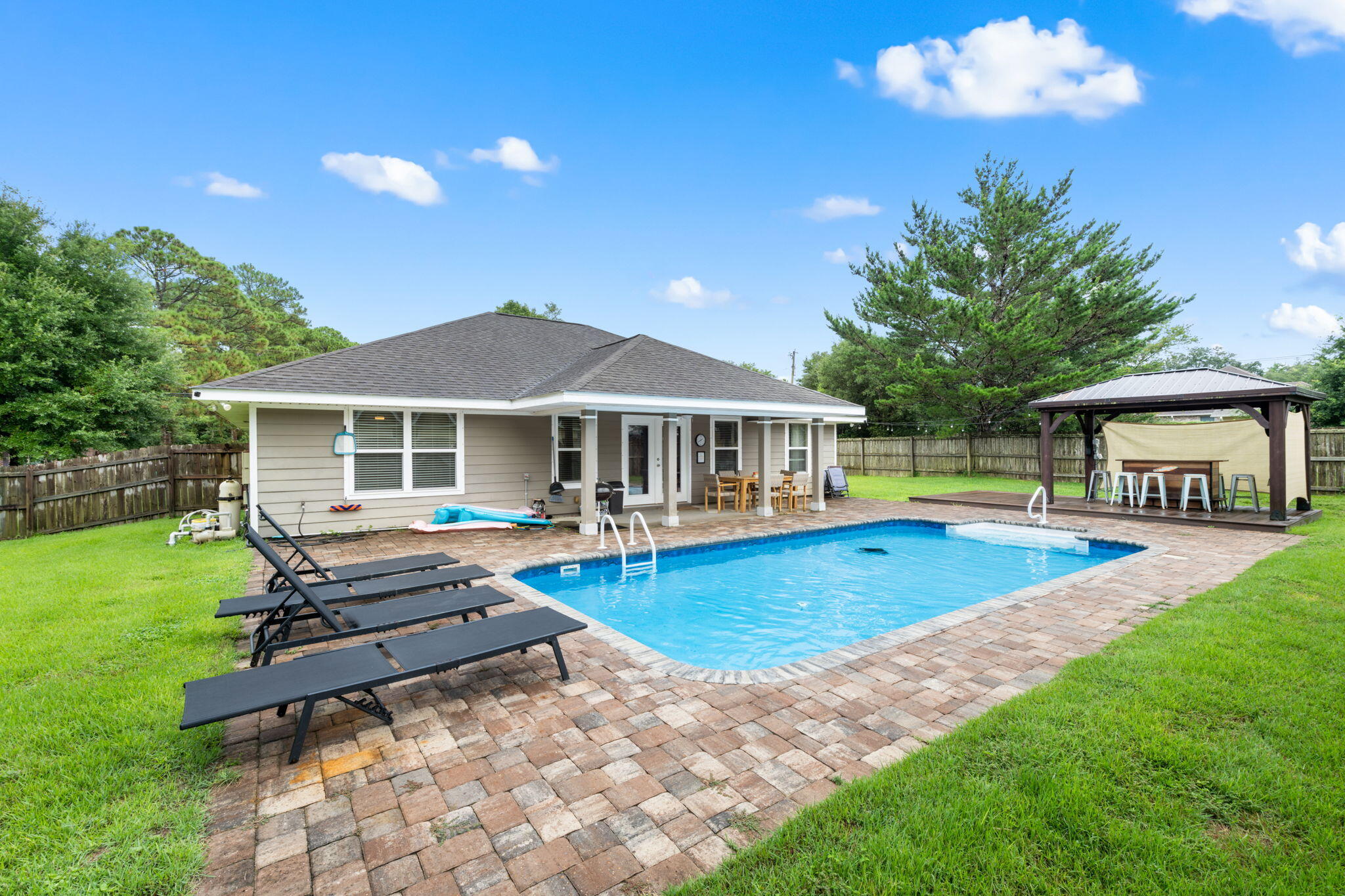 GORGEOUS POOL home with huge fenced in back yard. $90,000 was spent on SALTWATER pool, pavers, sod, new sprinkler heads, piping and analog irrigation. Backyard includes a covered patio AND a covered deck with bar. This 3 bedroom 2 bath is very open and perfect for entertaining. Large living room/kitchen/dining combination overlooking the covered patio and pool. Split bedrooms with the master bedroom and spare bedroom having views of the pool. Large master bedroom with 5-piece master bath with soaking tub and walk in closet. Built in 2014, this home is almost new! Interior features quartz countertops, soft close cabinets and stainless-steel appliances. Only 3 miles to the beach, this home would make a perfect primary residence or leave it as an AirBNB rental. Gross rentals for 2024 were $35,000 and so far for 2025 is $25,000. Best yet? NO HOA makes this large corner lot perfect to add onto the home; build a guest house or add boat or RV parking. All of the appliances including the washer and dryer and all furnishings convey. Situated in the heart of Navarre, so it will not last long. Call today!
Roof, HVAC and WH 2014