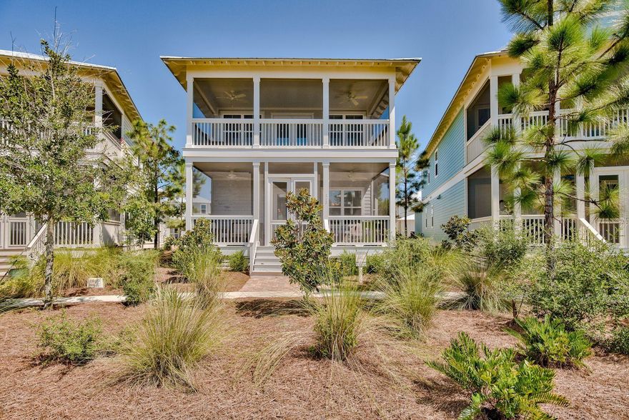 Ideal for those of all ages who love outdoor recreational activities, this spacious home in the Naturewalk community overlooks a peaceful green space within the protected Point Washington State Forest. Outdoor porches on both levels provide a space for outdoor living, dining, reading and socializing while watching the world go by. These screened spaces induce a slower pace of life with just the sound of birds in the fresh pine-scented air. From the porch, step inside this attractive Florida cottage and see the spacious floor plan open up before you. Attractive hardwood floors enrich the bright sitting area and dedicated formal dining space. The streamlined open kitchen with its built-in stainless steel appliances is perfect for modern-day living.
