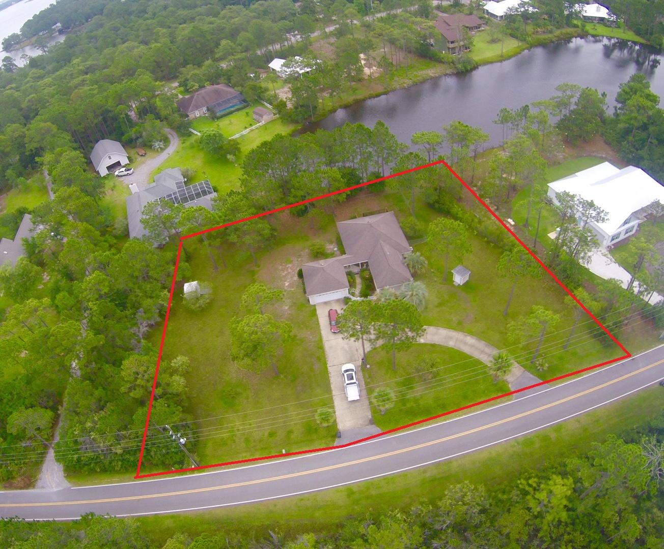 Well maintained 2bed 2bath in charming Woodland Bayou Estates. This house sits on a HUGE 1+ acre lot in heart of Santa Rosa Beach. In addition to being a large lot this property also has 50+ feet on a private lake. Perfect home for someone who owns a lawn-care or beach services business needing room to park/store equipment.