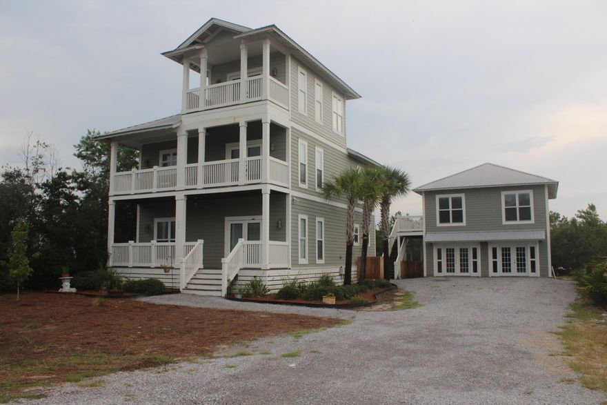 Beautiful vacation home or short term rental investment only one block off of county Road 30A! This property has a main house and a guest house! The main house features an open floor plan with kitchen opening to the eat in area and living room space. The kitchen has custom cabinets with granite counter tops and stainless and black appliances. In the main house there is a master bedroom with a full bath featuring a large whirlpool tub and separate walk in shower. In addition there is a bedroom on the first floor, two bedrooms on the second floor, and another room on the top floor that could be used as a game room! There are three full baths, a large laundry room, and plenty of closet and storage space. Each floor features a covered patio/deck space for rocking chairs and outdoor furniture
