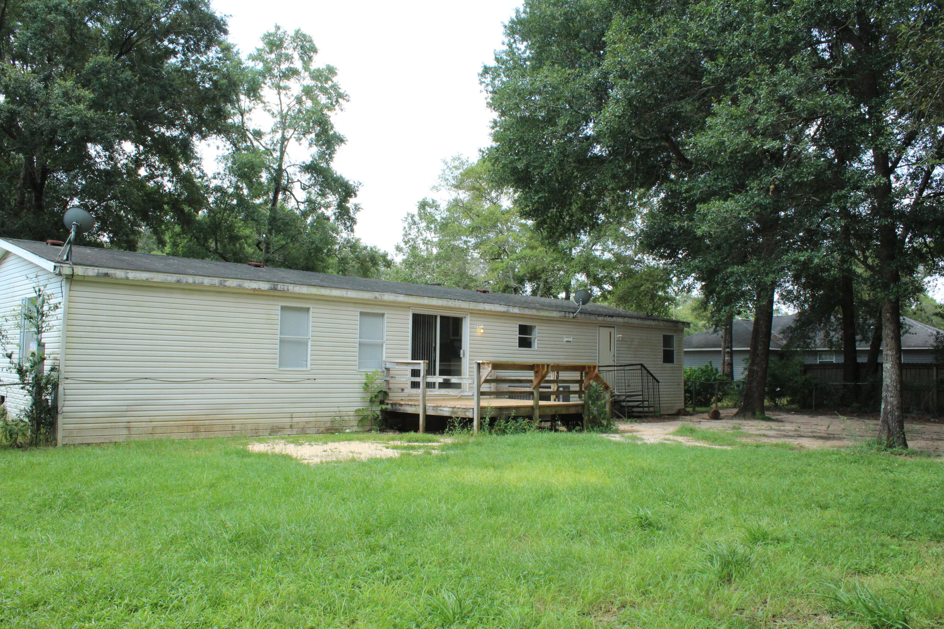 Back On Market with Kick Out Clause!!! Accepting Back Up offers! Great 4 bedroom and 2 bath home with 1782 sq ft located in Milton FL. This home is in a very nice subdivision that is an easy drive to restaurants, shops, schools, and churches! The home features two large family rooms! The kitchen opens to both living rooms and has a peninsula that seats 2. There is a good sized laundry off the kitchen that also opens to the back yard! The kitchen overlooks the backyard and open deck! There is a sliding glass door to the deck! Also there is a wood deck on the front of the home. The master bedroom has an ensuite bathroom with a soaking tub, walk in shower, and double vanity. Buyer to verify all dimensions and information.