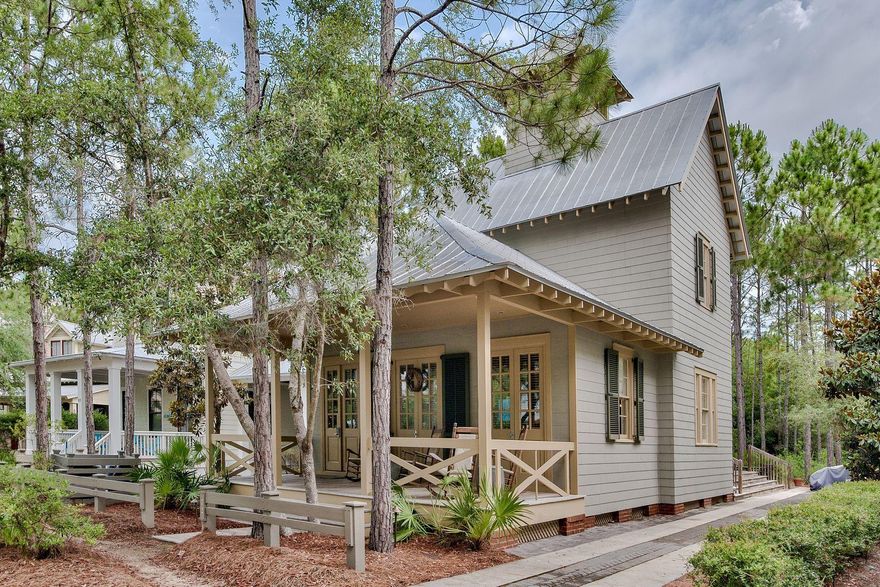 This charming, Phase 2, WaterColor beach home is in excellent condition and ready to enjoy. Located off the main road on Thicket Circle, this home is fronted by a small park and has green space behind offering extra space and privacy. A large front porch, ideal for sitting and enjoying a drink, greets you as you walk up. The long driveway can accommodate several cars. The living room is on the front of the home. The open kitchen and dining provide plenty of space and a french door off the dining room to the back side deck is ideal for grilling. Built-ins add plenty of storage space in the dining area and along the hallway to the master, which is conveniently located on the first floor. There is a laundry room and half bathroom on the first floor as well.