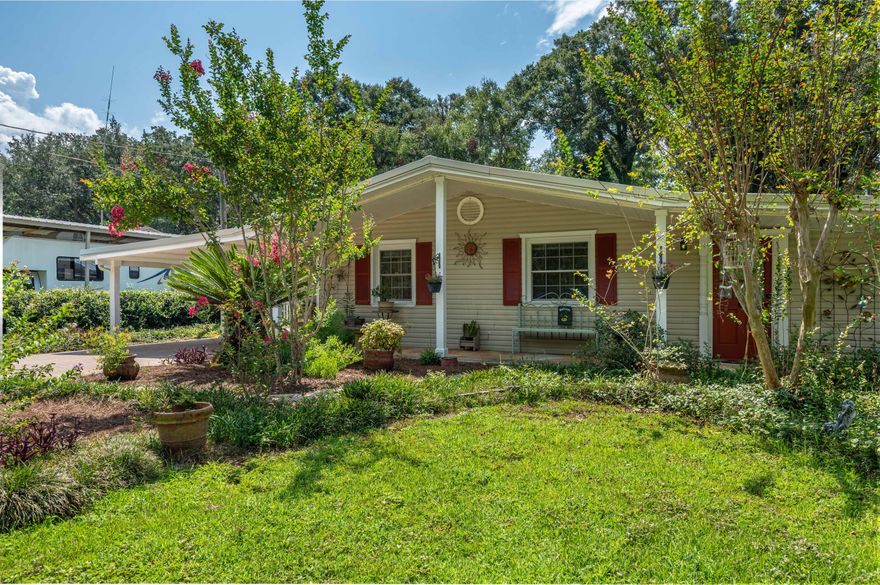 Charming storybook cottage home with views of the bay! Perfect for RV home base or second home. Completely renovated including smooth ceilings, tile floors, crown molding, bead board. Nice large windows throughout the home allow the florida sun to filter in all the rooms. Enjoy view of the bay with morning coffee! Views from the bay are seen from the master bedroom, office, screened in lanai, kitchen and front porch. Beautiful lush yard with cypress trees and an outdoor shower. RV power outlet in the yard. The apartment/workshop adjacent to the carport has half bath in it and lots of storage! Perfect for an Air BNB! Gem of a home and well maintained. Located just a hop, skip and jump from the mid bay bridge.  Roof 2023, Water Heater 2023, HVAC 2023. NO HOA!