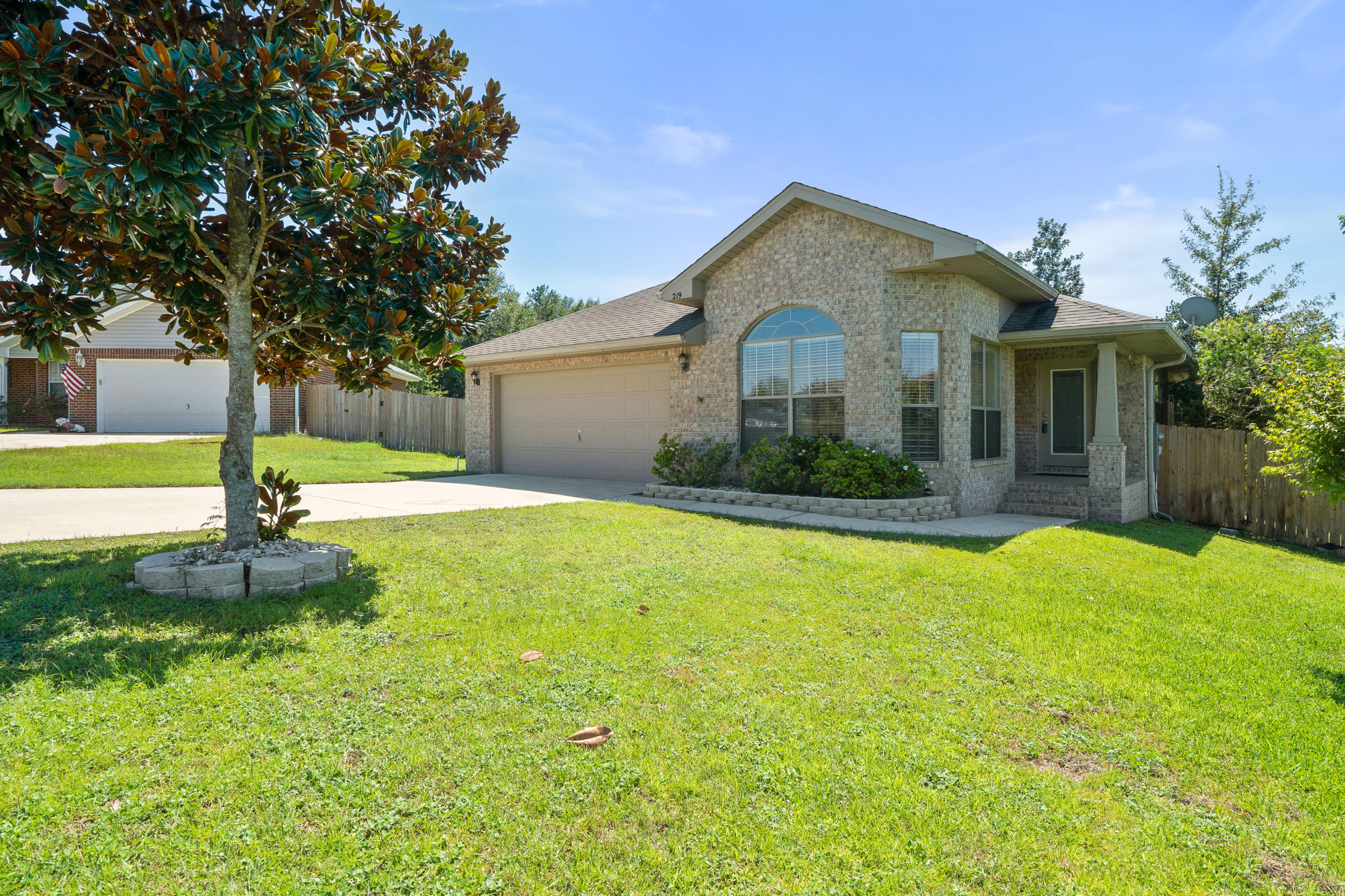 SOUTH CRESTVIEW GEM! This 2010-built gorgeous 3 Bedroom/2 Bath/2-Car Garage, all-brick home in South Crestview is in immaculate condition and ready for its new owner! With a newly painted interior, this stylish 1317-SF one-level home is full of thoughtful features for the discerning homeowner to include vaulted and treyed ceilings, large eat-in Kitchen with 3 large windows bringing in tons of natural light, wood-burning fireplace feature in Living Room, and an elevated covered Rear Deck off the Living Room overlooking the large private backyard - such a tranquil place to relax and unwind! This turnkey home has concrete stained floors throughout, with newly installed ceramic wood-look tile in Kitchen and Baths. Master Bedroom features access to the covered Rear Deck also.