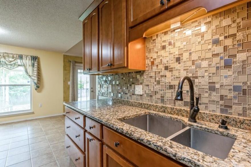 Welcome to this stunning South Crestview gem ideally situated on a desirable corner lot, offering quick and easy access to local military bases and the world-famous Emerald Coast beaches. This well-designed home features a split-bedroom floor plan with four bedrooms plus a dedicated office, giving you the flexibility and space your lifestyle demands.  Step into the cook's dream kitchen, complete with granite countertops, an eye-catching custom backsplash, soft-close drawers, and stainless-steel appliances.  Outside, the corner lot offers endless possibilities--whether you envision a pool, a garden, or expanded outdoor living. Enjoy the existing 12'x24' covered patio, ideal for relaxing or entertaining year-round. A backyard storage shed adds even more convenience and utility.