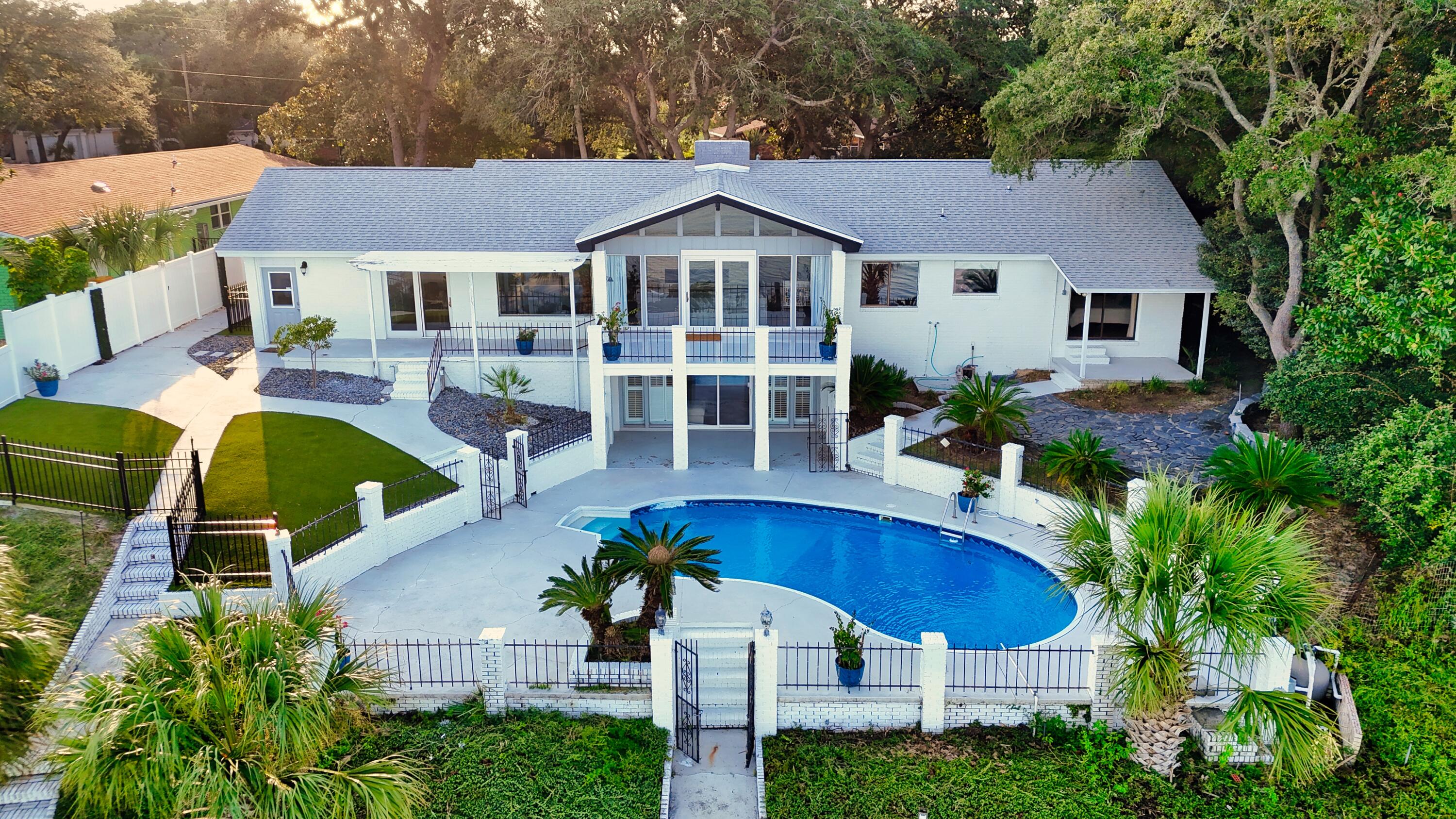 New photos coming soon. Back on the market after numerous new updates, house is now fully renovated. Most recent updates include: large 9x6' master closet, office/den, secondary bedroom has new walk in closet, fresh paint in/out, and more.Amazing Waterfront Property with endless views. Water views from the majority of the house. Located on Choctawhatchee Bay near Shalimar Pointe Golf Course. Beautifully updated kitchen with tons of counter/cabinet space, has a full size wine fridge on the main floor and a small wine fridge downstairs. The house has endless storage and lives like a much larger house. The Living Room has beamed, vaulted ceilings, a gas fireplace, and walks out to the upper patio. Off the living room is a den/office with water views. Downstairs you will find an additional bonus space with a built in bar, fireplace, and direct access to the pool area through slider doors. Outdoors there is ~5k sq ft of terraces with turquoise water views, fenced in, and very private.
There is a newer dock with a boatlift. A new roof was installed in 2021. Privacy as the house is near the end of dead end street. No HOA. Also has potential for short term rental income.